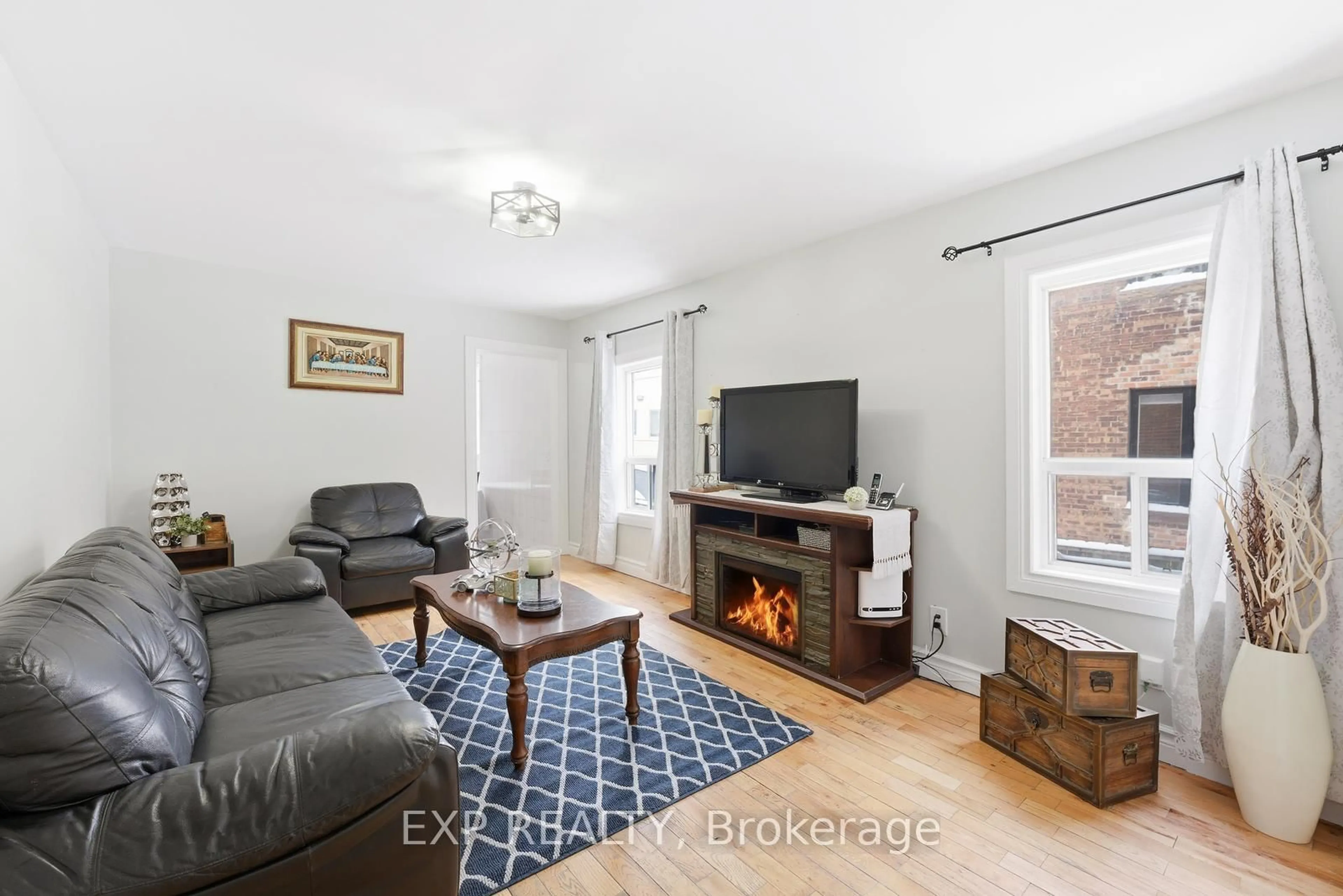 Living room with furniture, wood/laminate floor for 20 Muir Ave, Toronto Ontario M6H 1E8