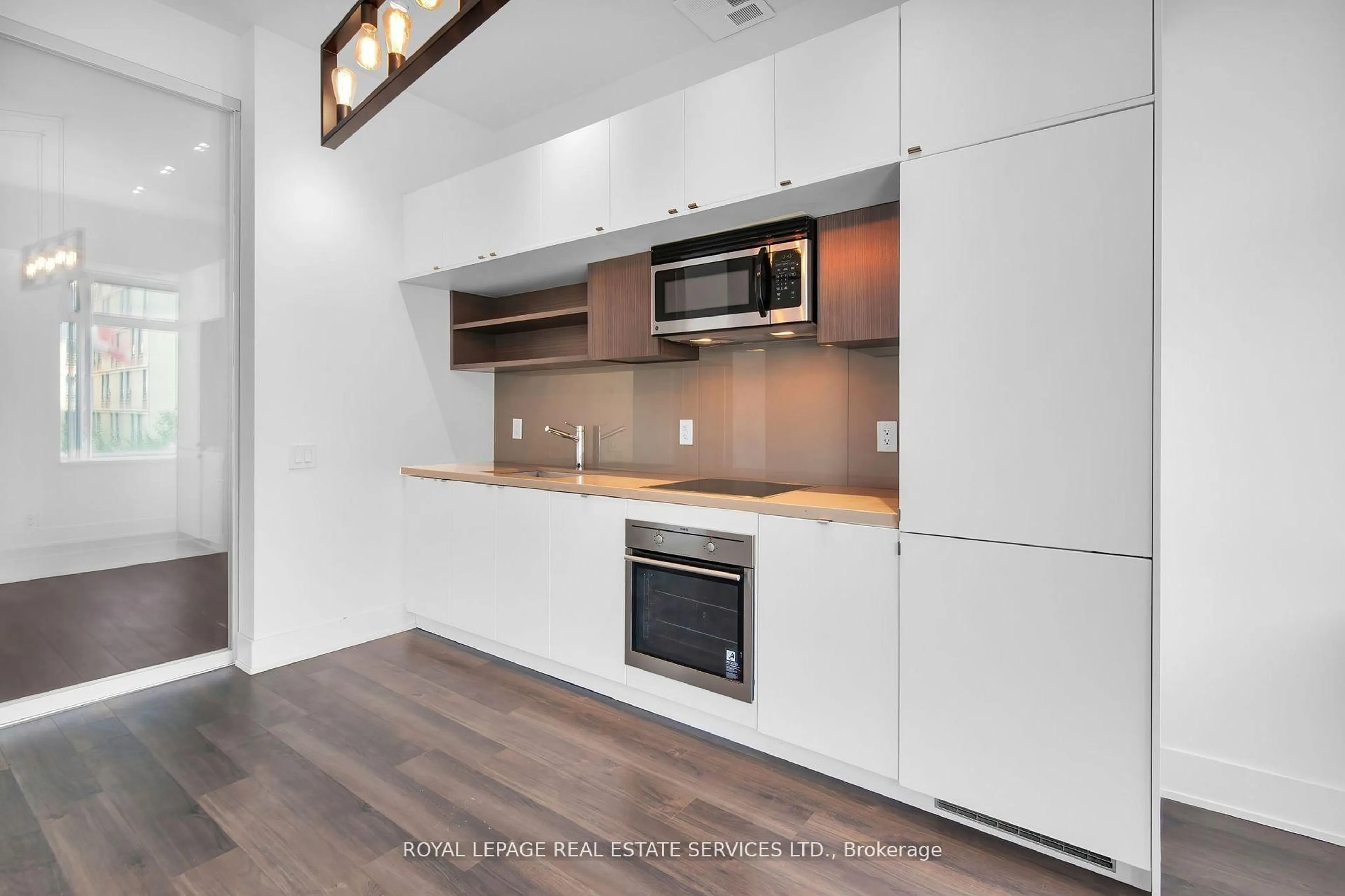 Open concept kitchen, wood/laminate floor for 111 St Clair Ave #402, Toronto Ontario M4V 1N5