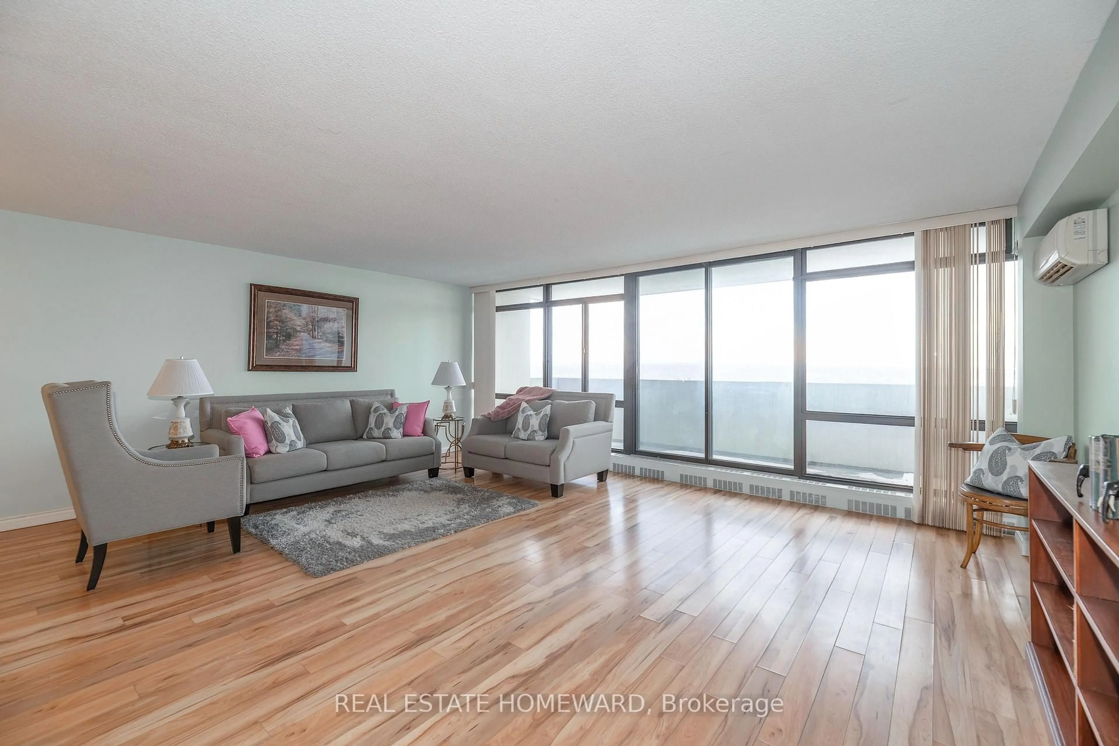 Living room with furniture, wood/laminate floor for 3300 Don Mills Rd #1202, Toronto Ontario M2J 4X7