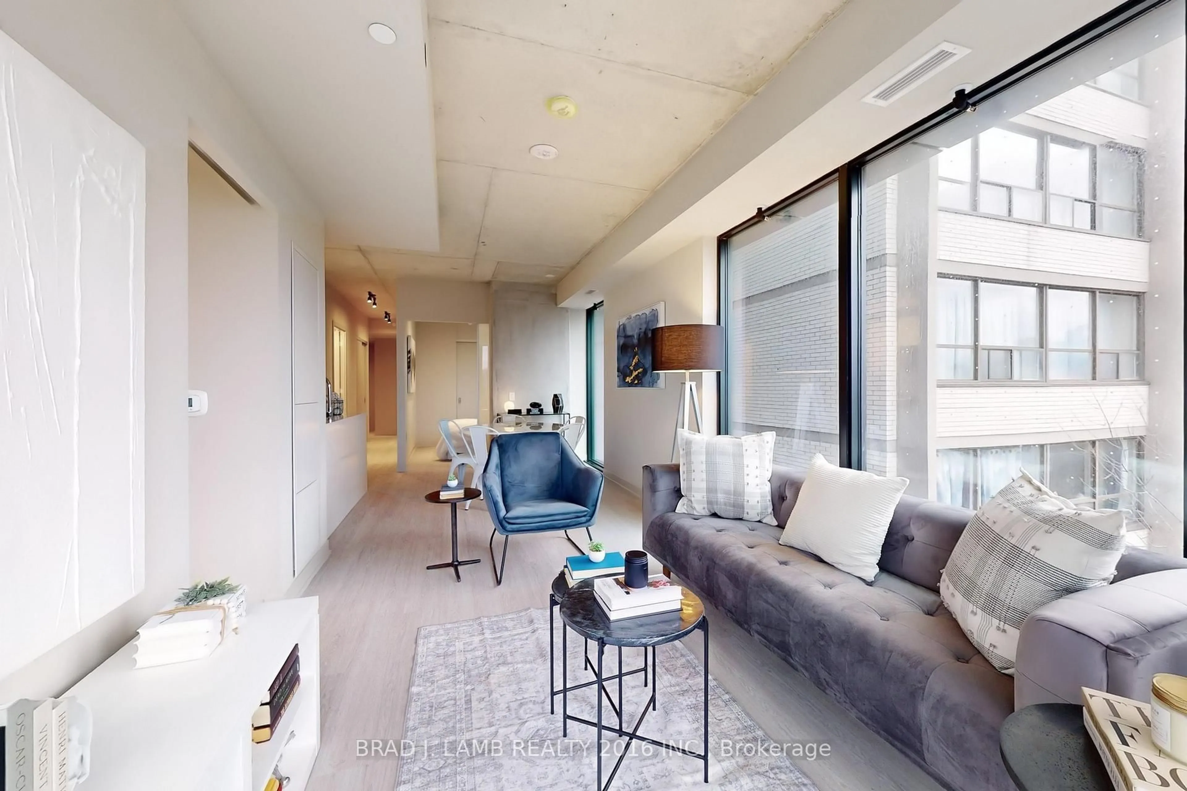 Living room with furniture, cement floor for 195 McCaul St #518, Toronto Ontario M5T 0E5