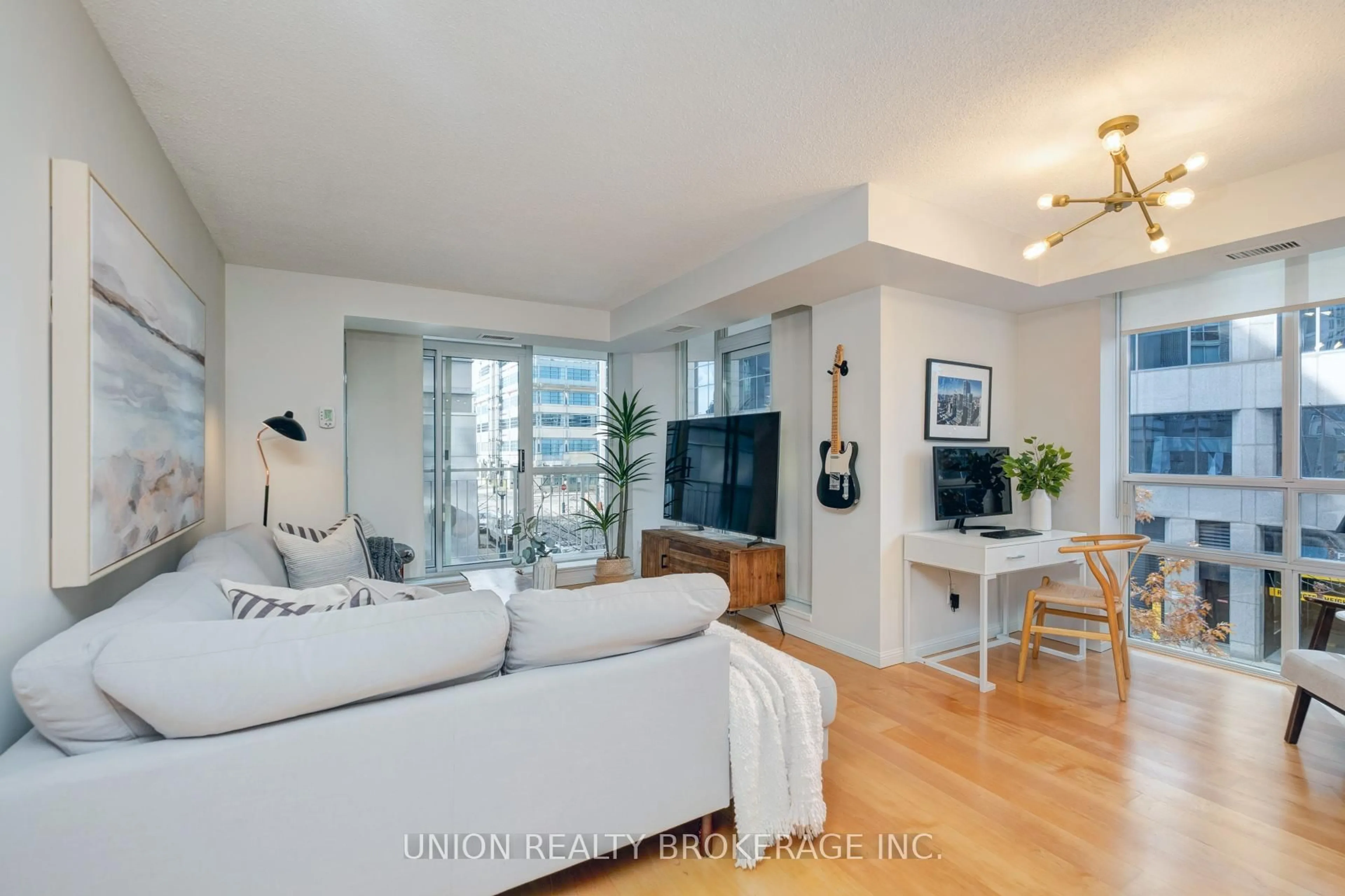Living room with furniture, wood/laminate floor for 18 Stafford St #313, Toronto Ontario M5V 3W4