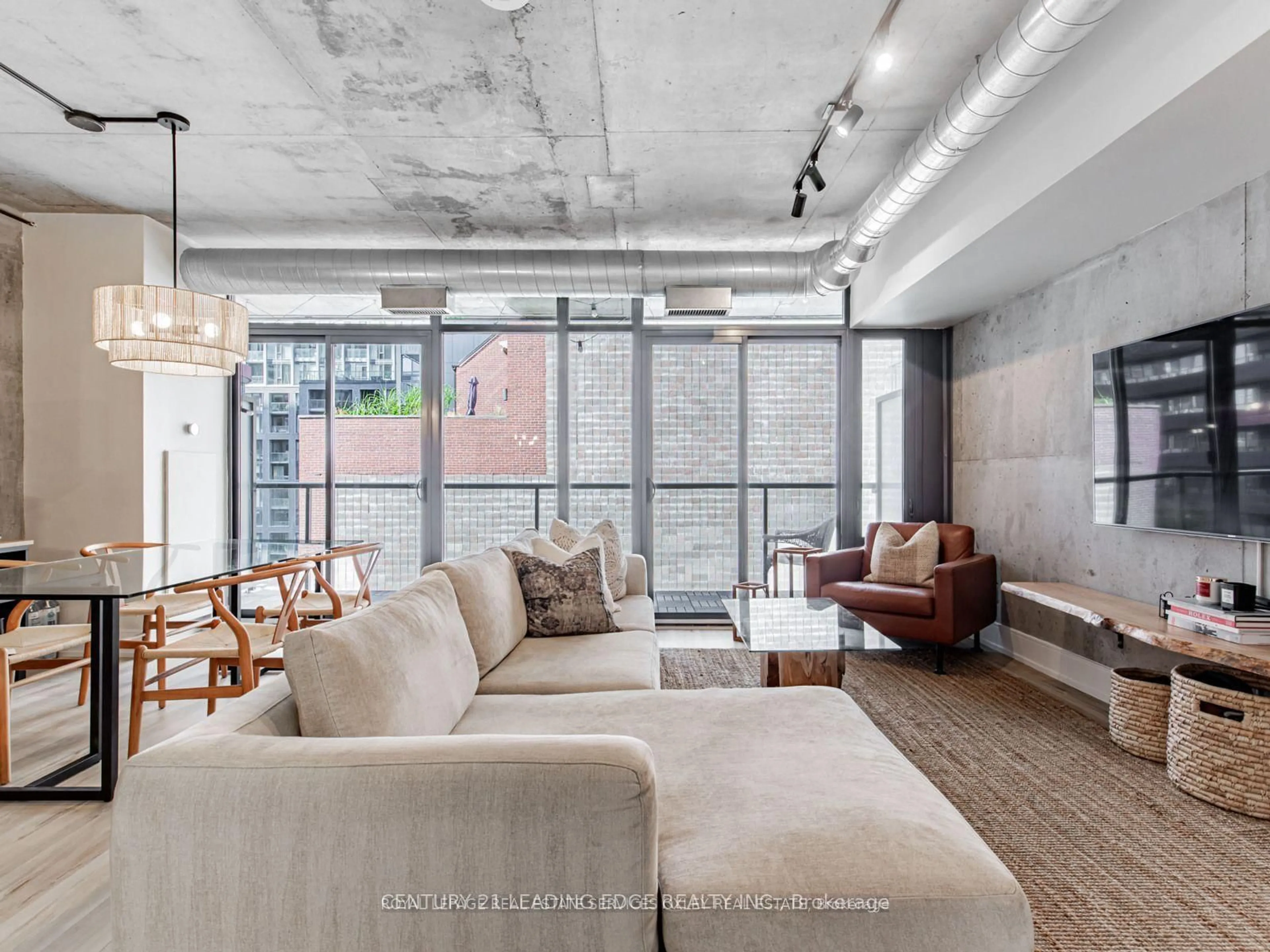 Living room with furniture, cement floor for 138 Princess St #515, Toronto Ontario M5A 0B1