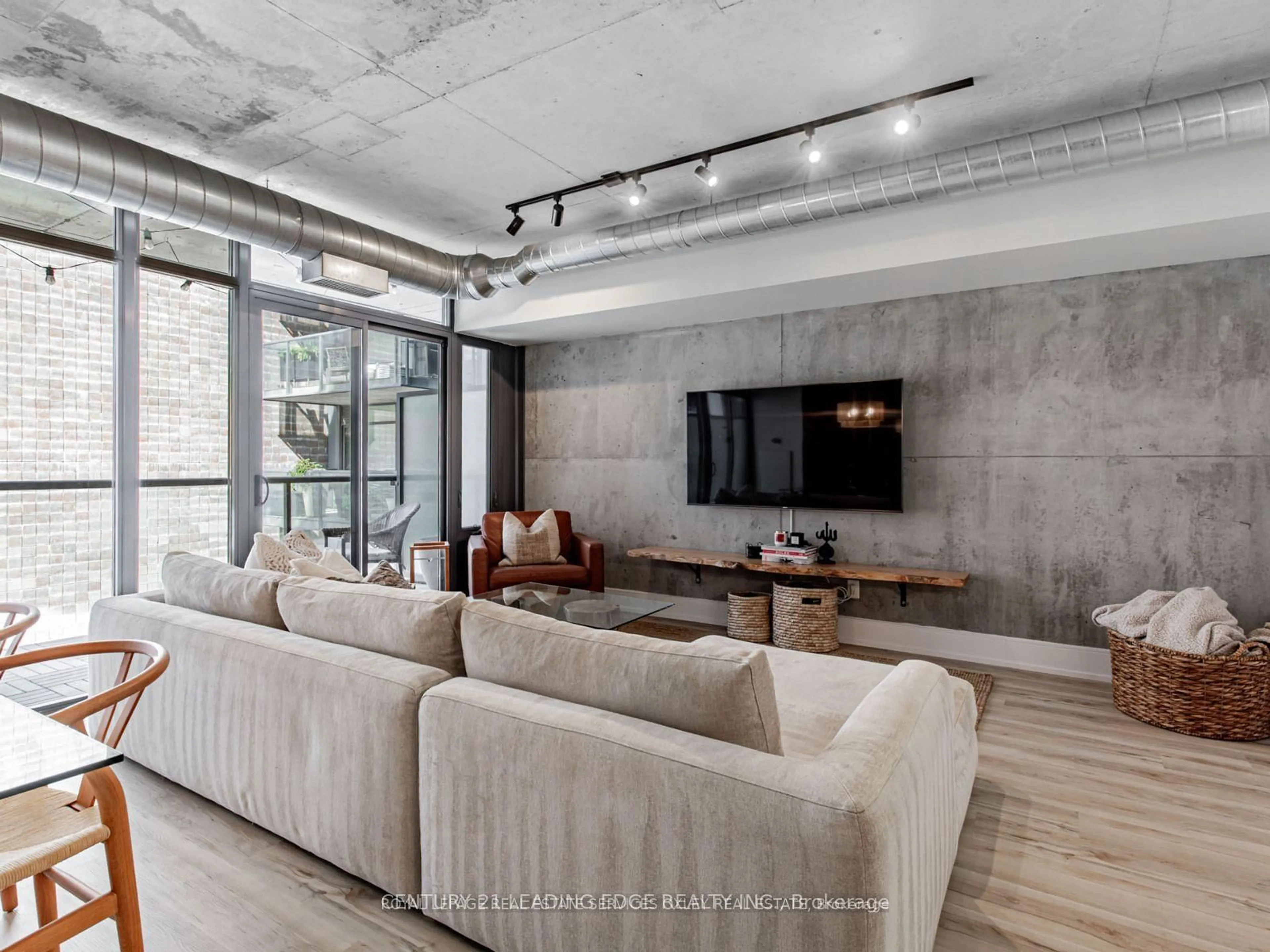 Living room with furniture, cement floor for 138 Princess St #515, Toronto Ontario M5A 0B1