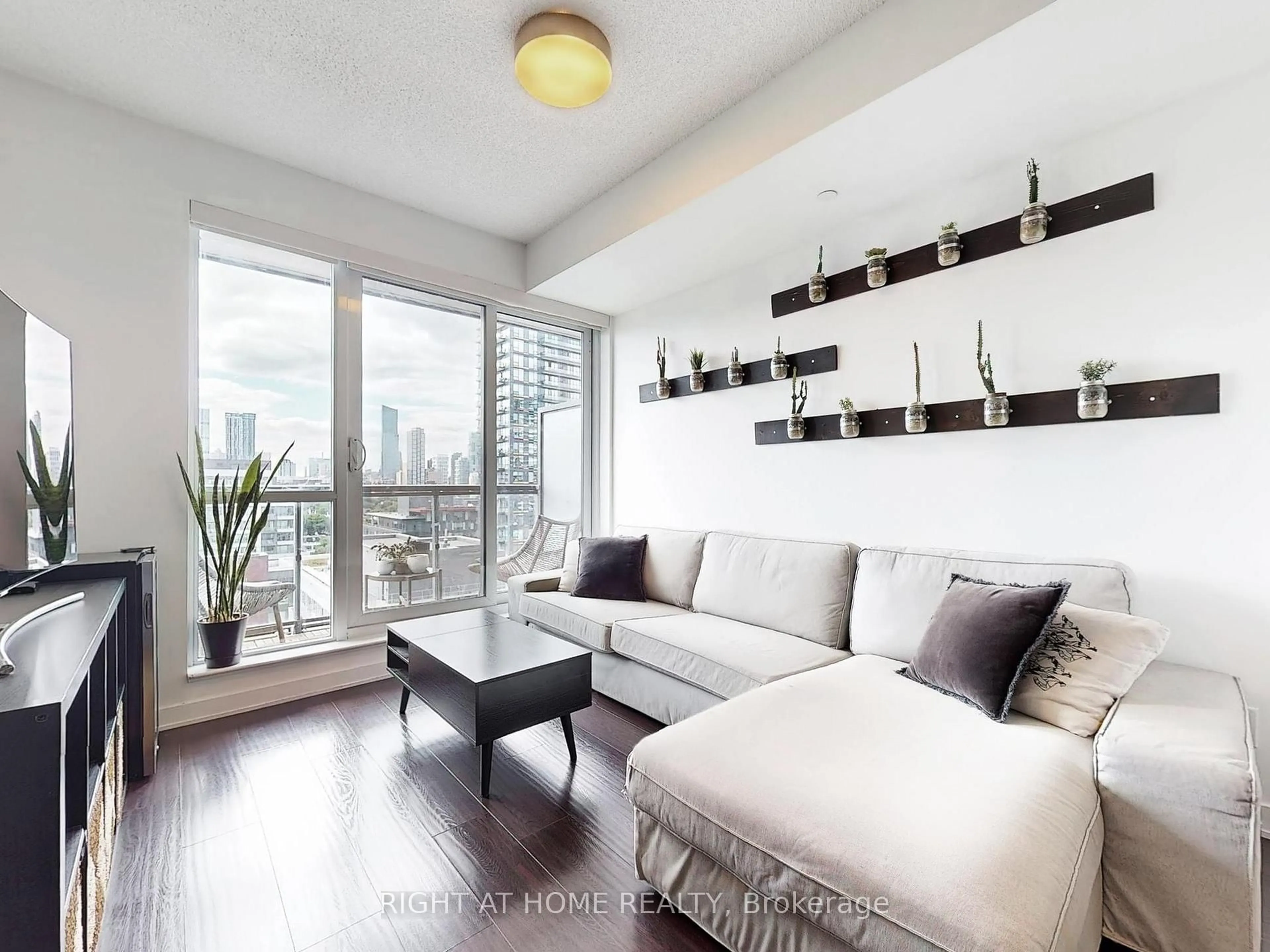 Living room with furniture, wood/laminate floor for 55 Regent Park Blvd #1407, Toronto Ontario M5A 0C2