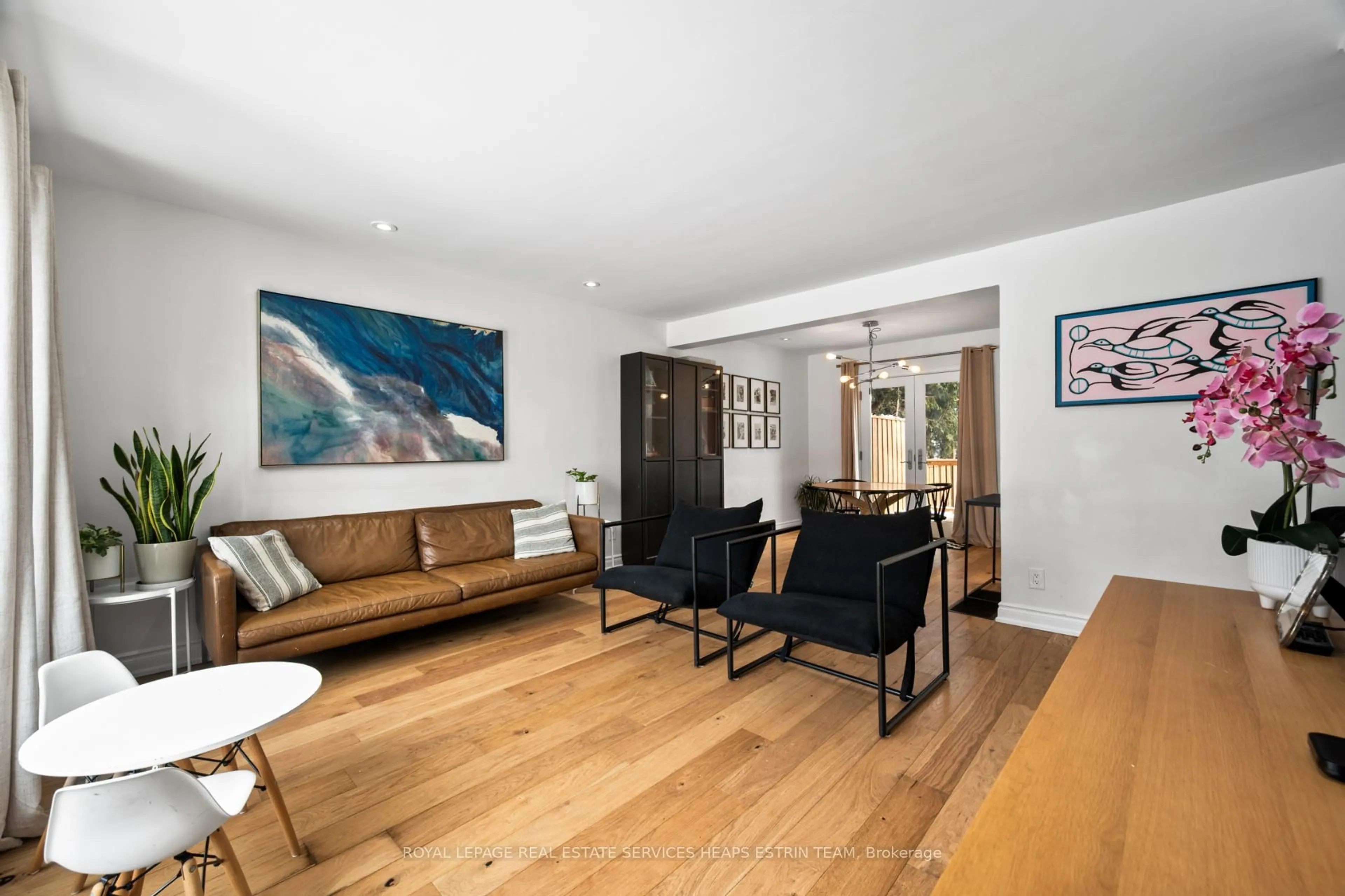 Living room with furniture, wood/laminate floor for 130 Barber Greene Rd, Toronto Ontario M3C 2A5