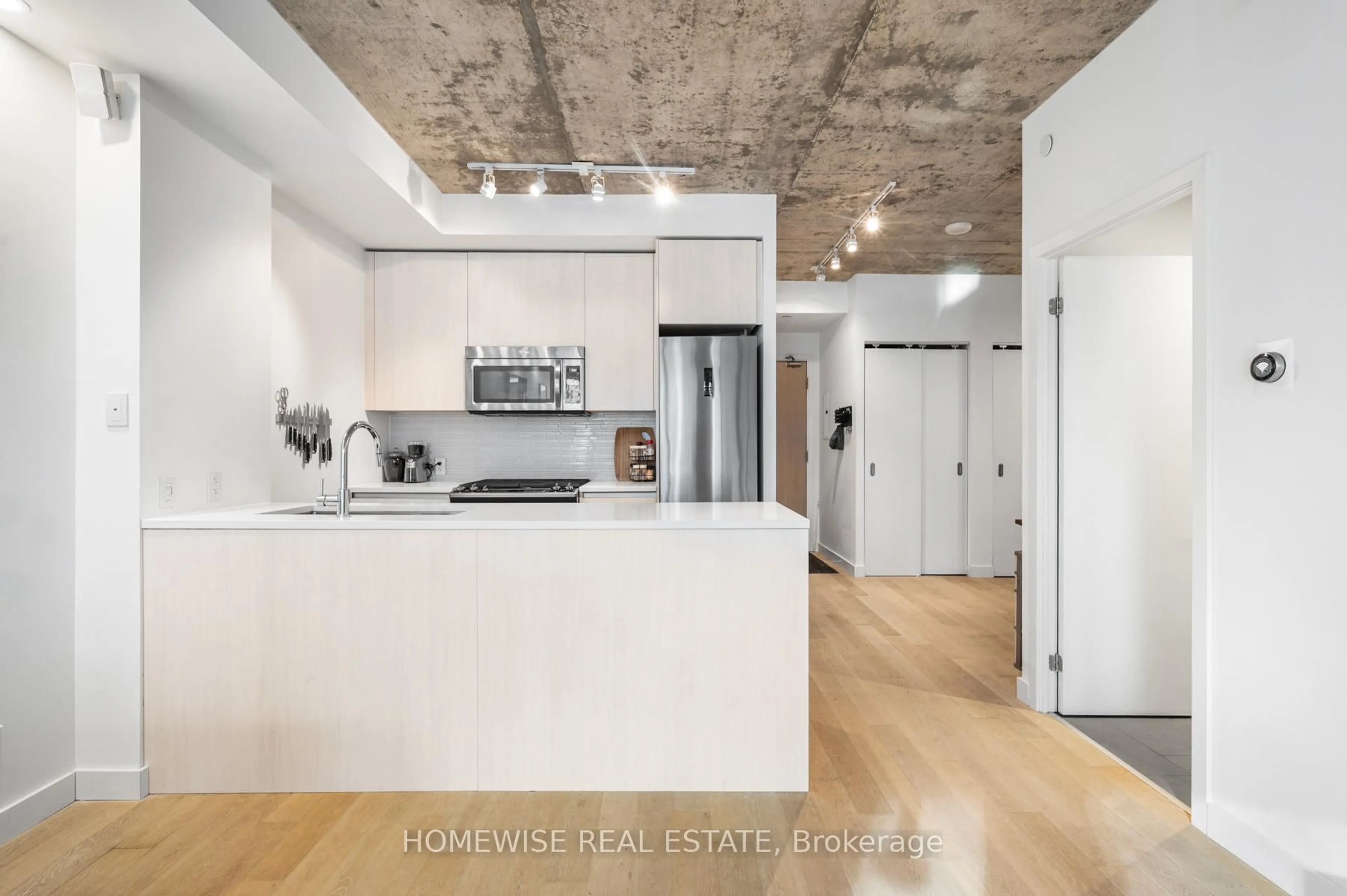 Open concept kitchen, cement floor for 111 Bathurst St #1009, Toronto Ontario M5V 2R1