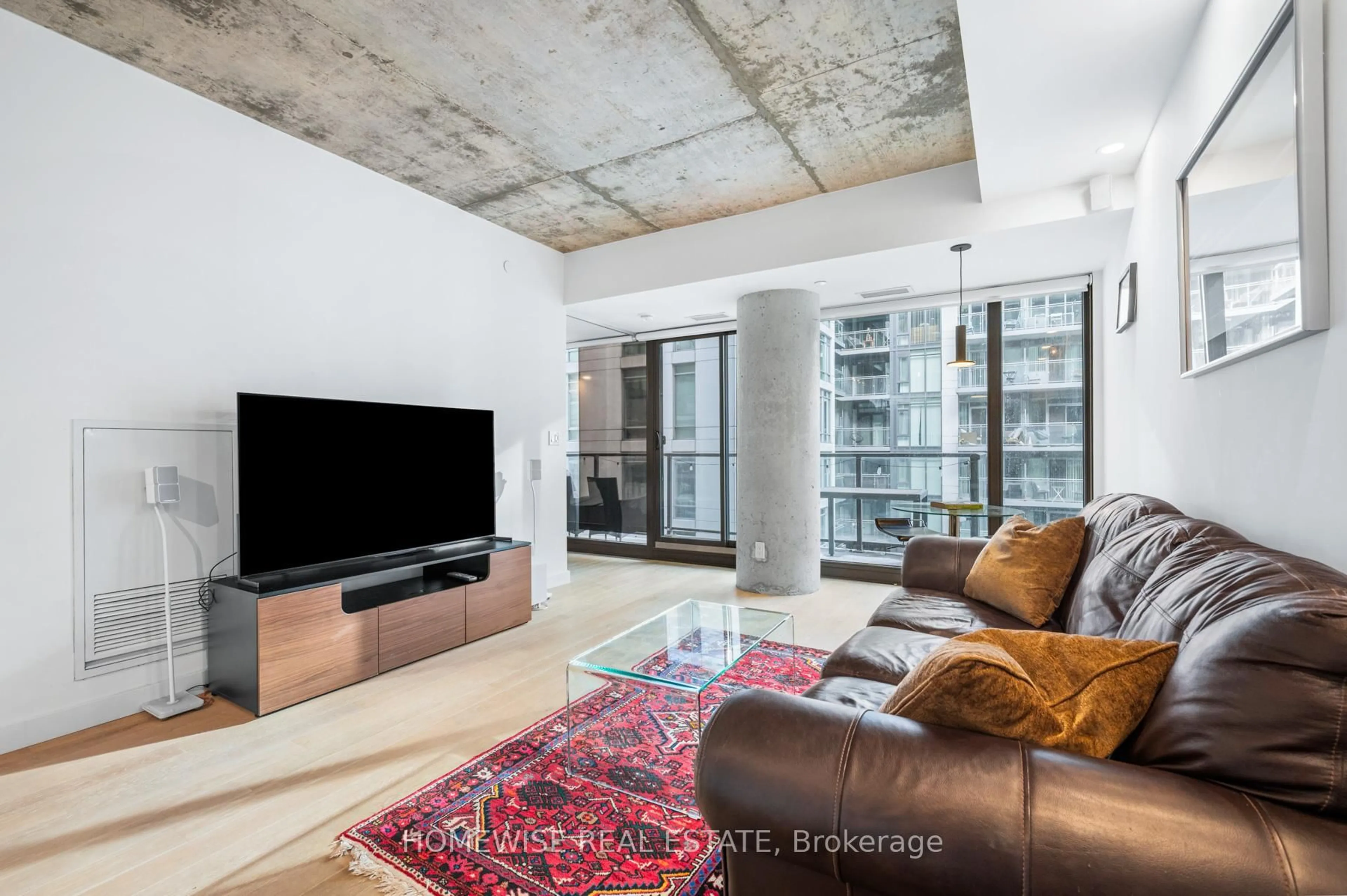 Living room with furniture, cement floor for 111 Bathurst St #1009, Toronto Ontario M5V 2R1