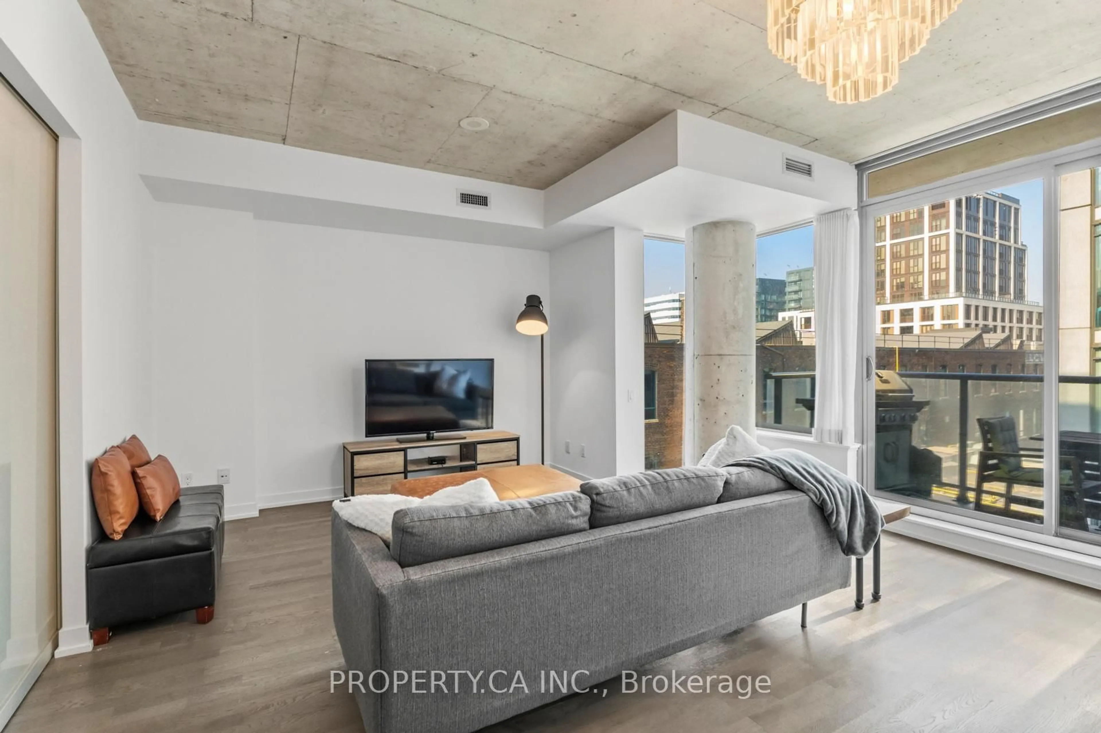 Living room with furniture, cement floor for 560 King St #623, Toronto Ontario M5V 1M3