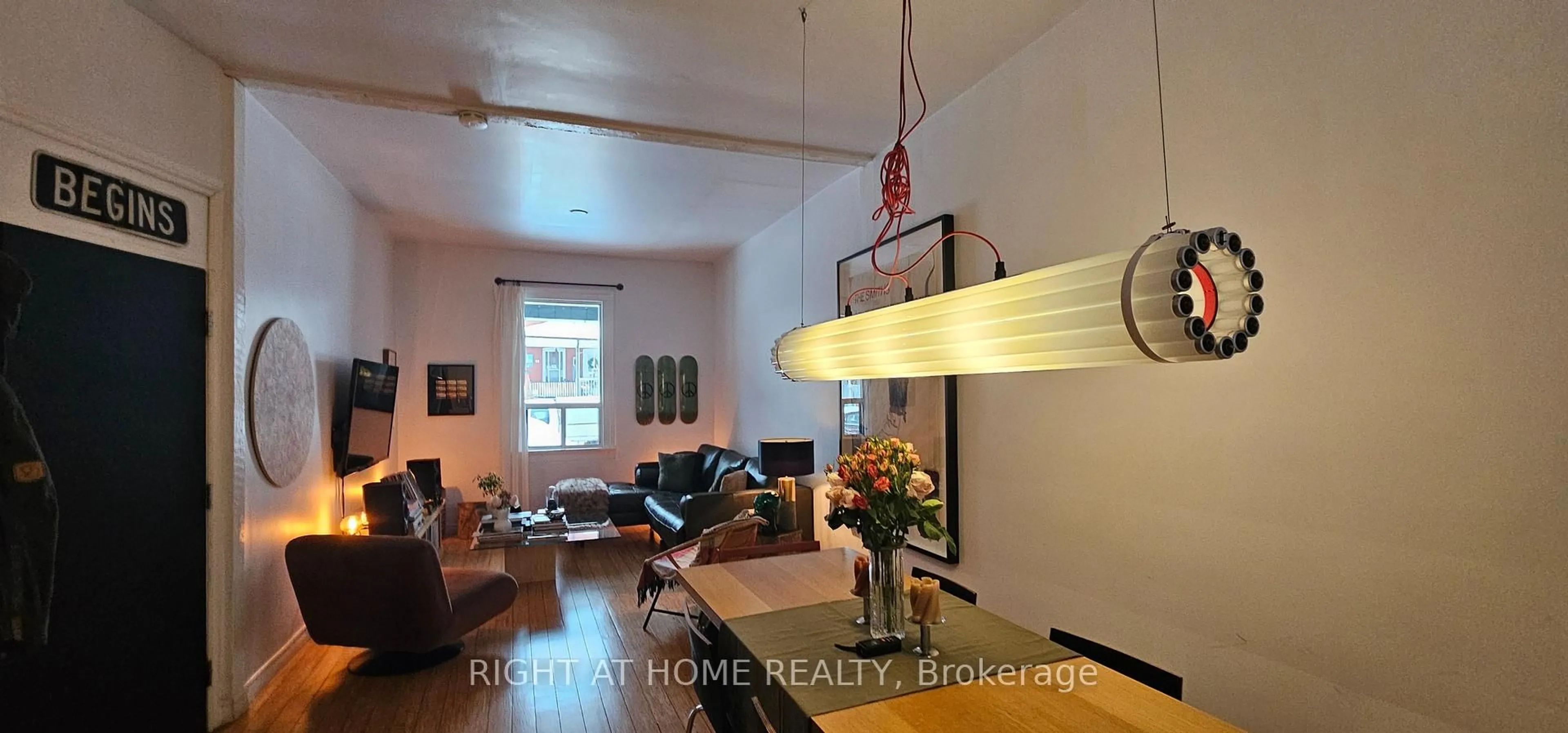 Living room with furniture, wood/laminate floor for 33 Foxley St, Toronto Ontario M6J 1P9