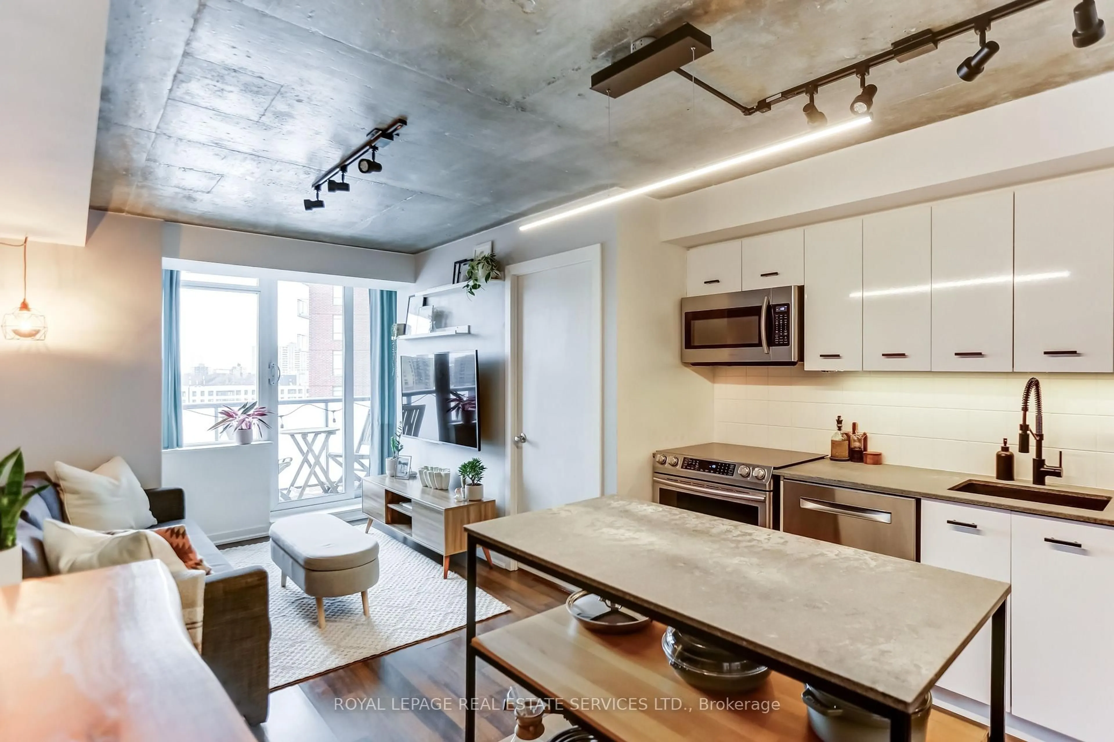 Open concept kitchen, cement floor for 20 Joe Shuster Way #1117, Toronto Ontario M6K 0A3