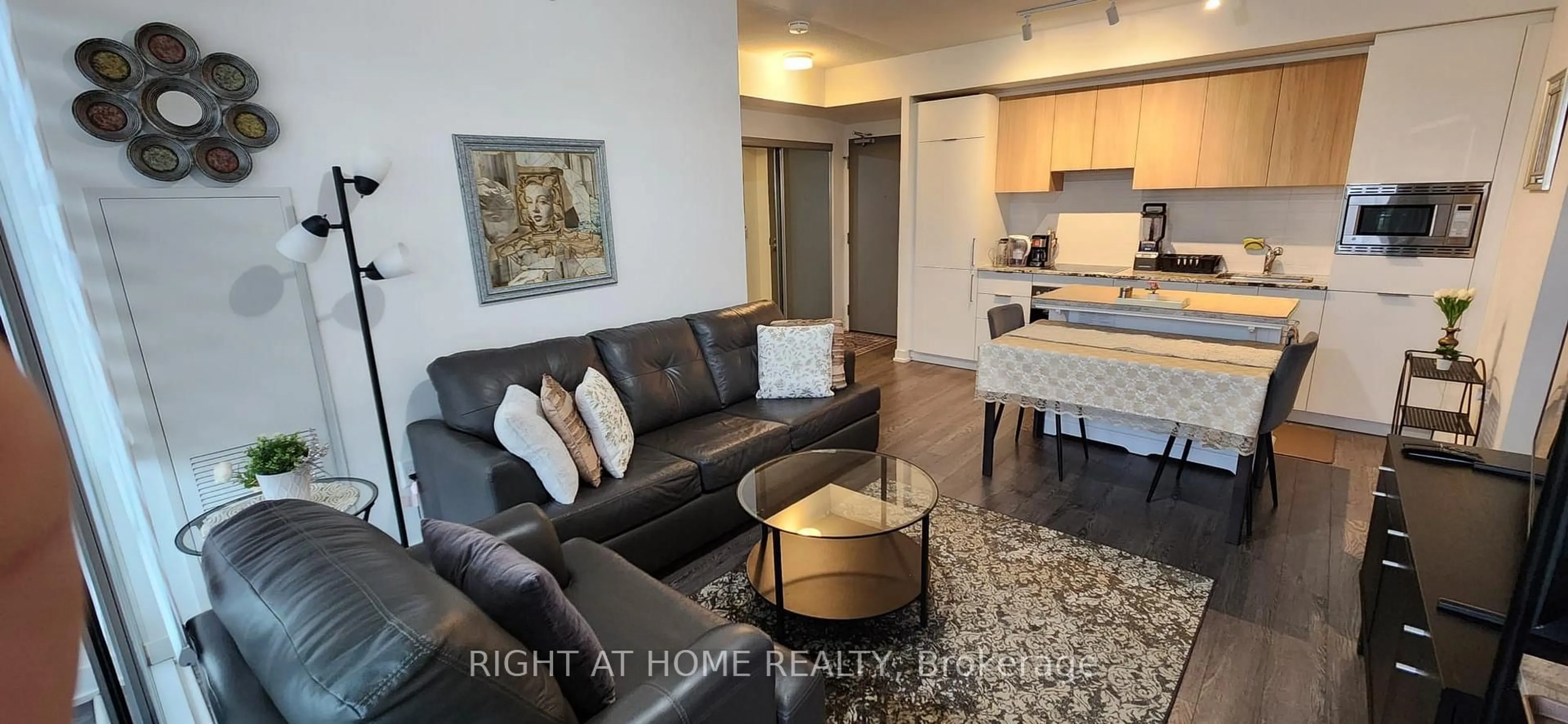 Living room with furniture, wood/laminate floor for 20 O'Neill Rd #527, Toronto Ontario M3C 0R2