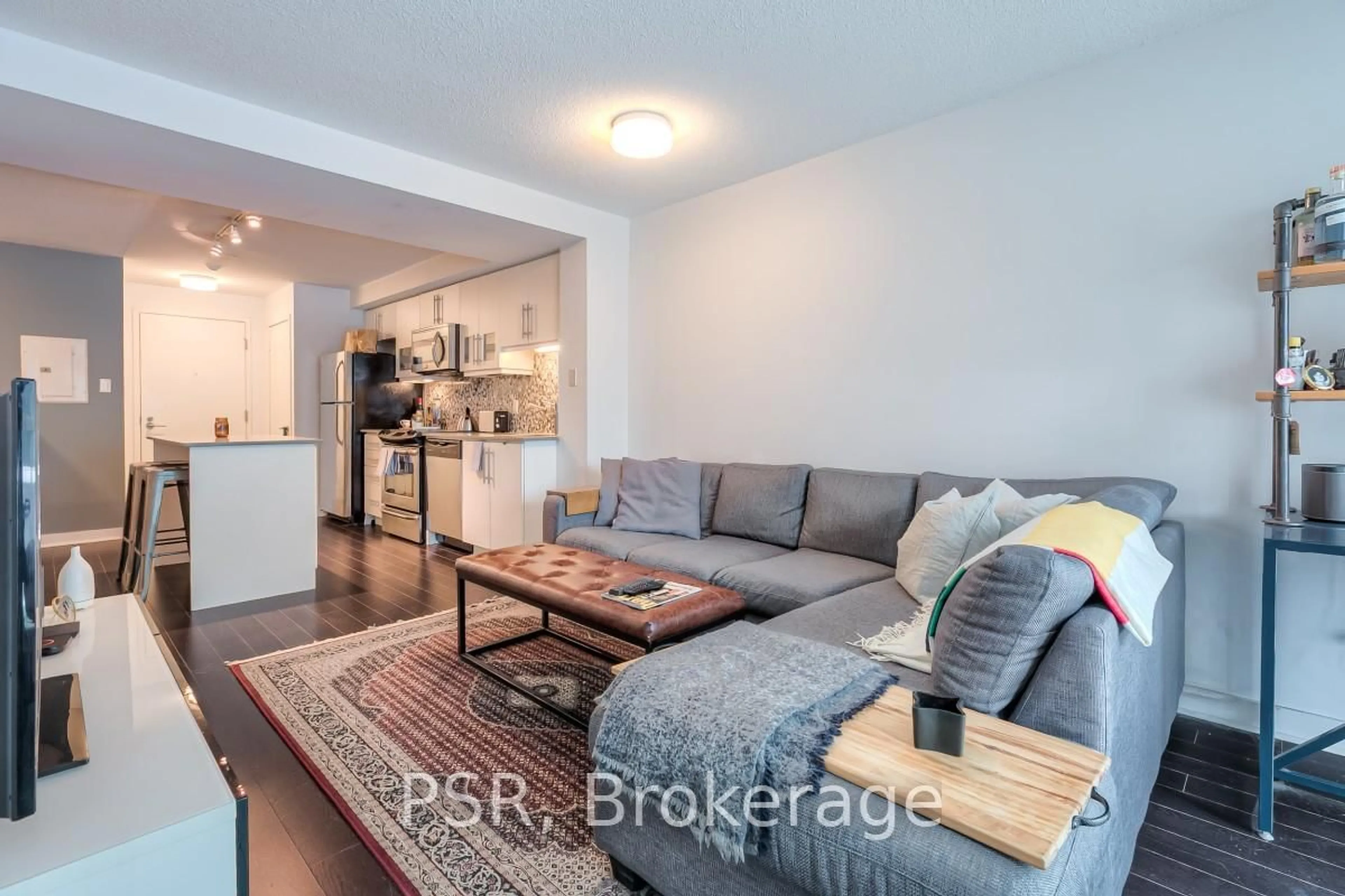 Living room with furniture, wood/laminate floor for 1169 Queen St #302N, Toronto Ontario M6J 0A4