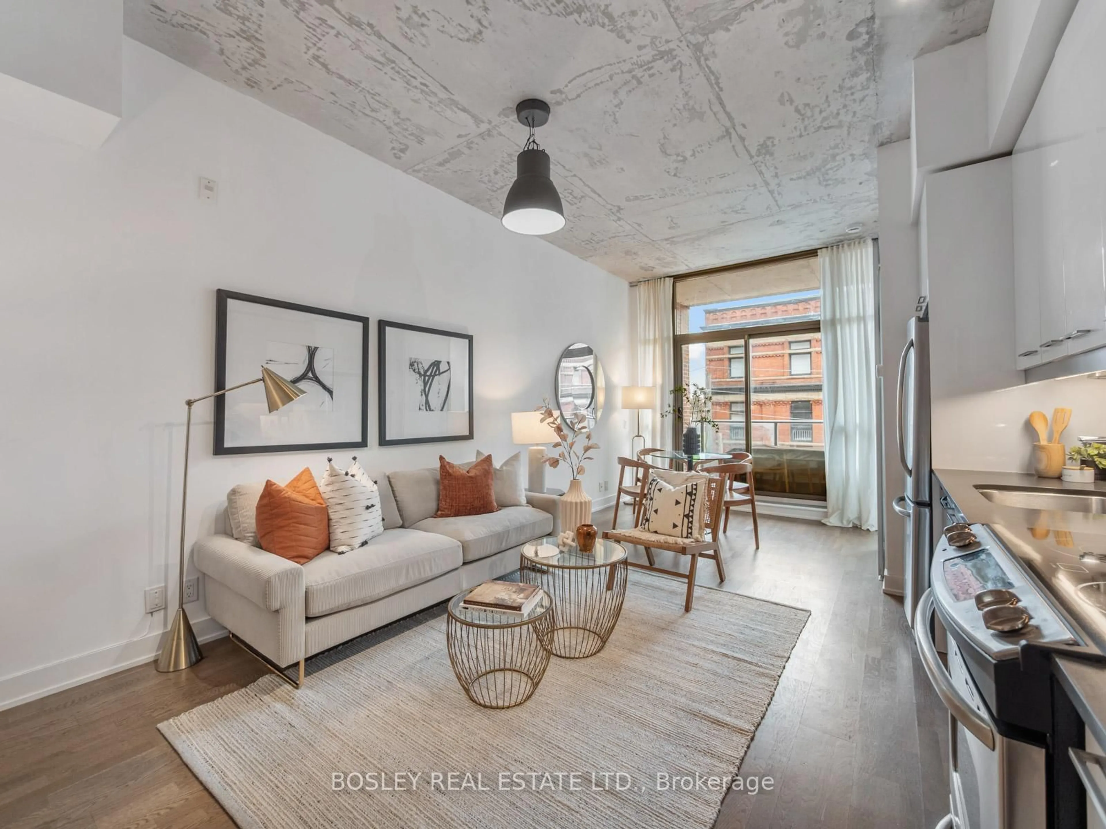 Living room with furniture, cement floor for 2 Gladstone Ave #404, Toronto Ontario M6J 0B2