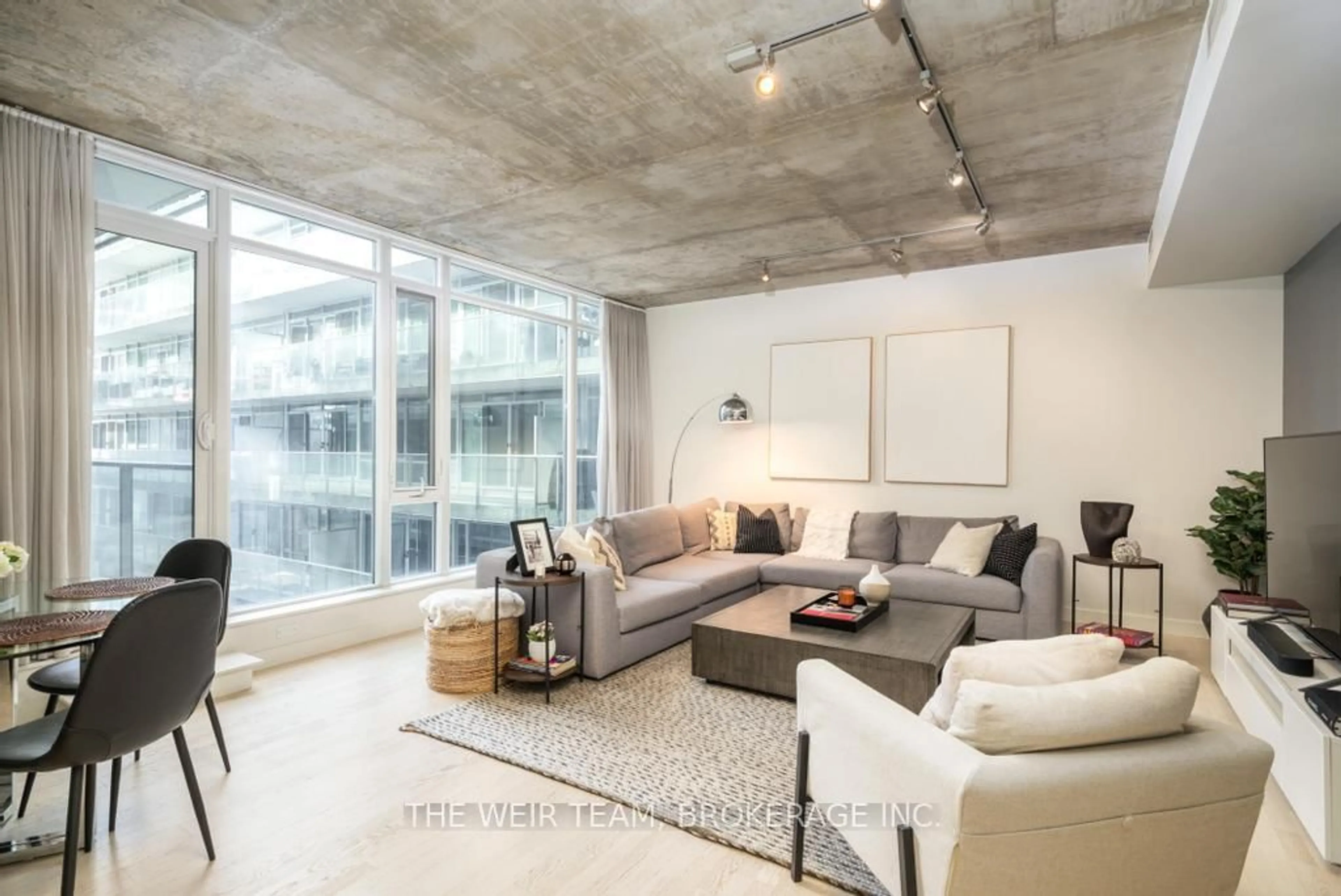 Living room with furniture, cement floor for 75 Portland St #718, Toronto Ontario M5V 2M9