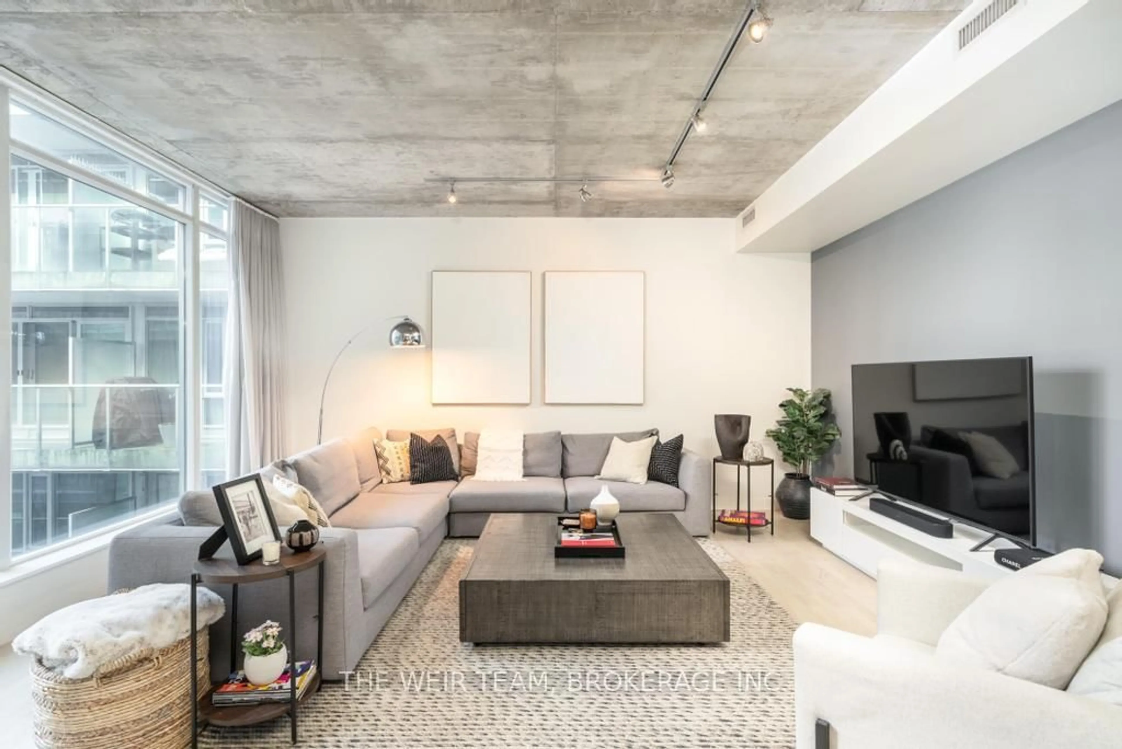 Living room with furniture, cement floor for 75 Portland St #718, Toronto Ontario M5V 2M9