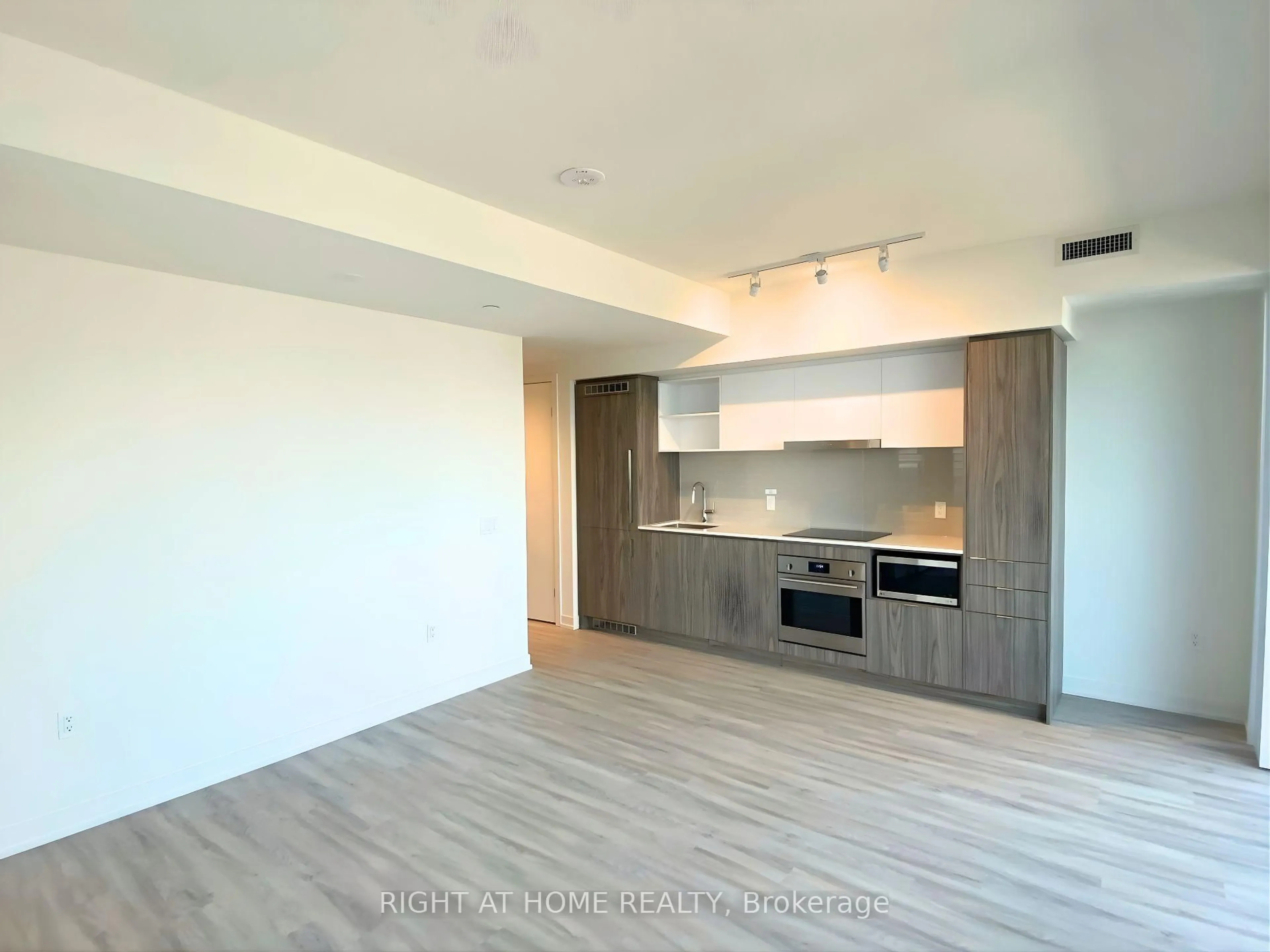 Open concept kitchen, wood/laminate floor for 55 Cooper St #4005, Toronto Ontario M5E 0G1