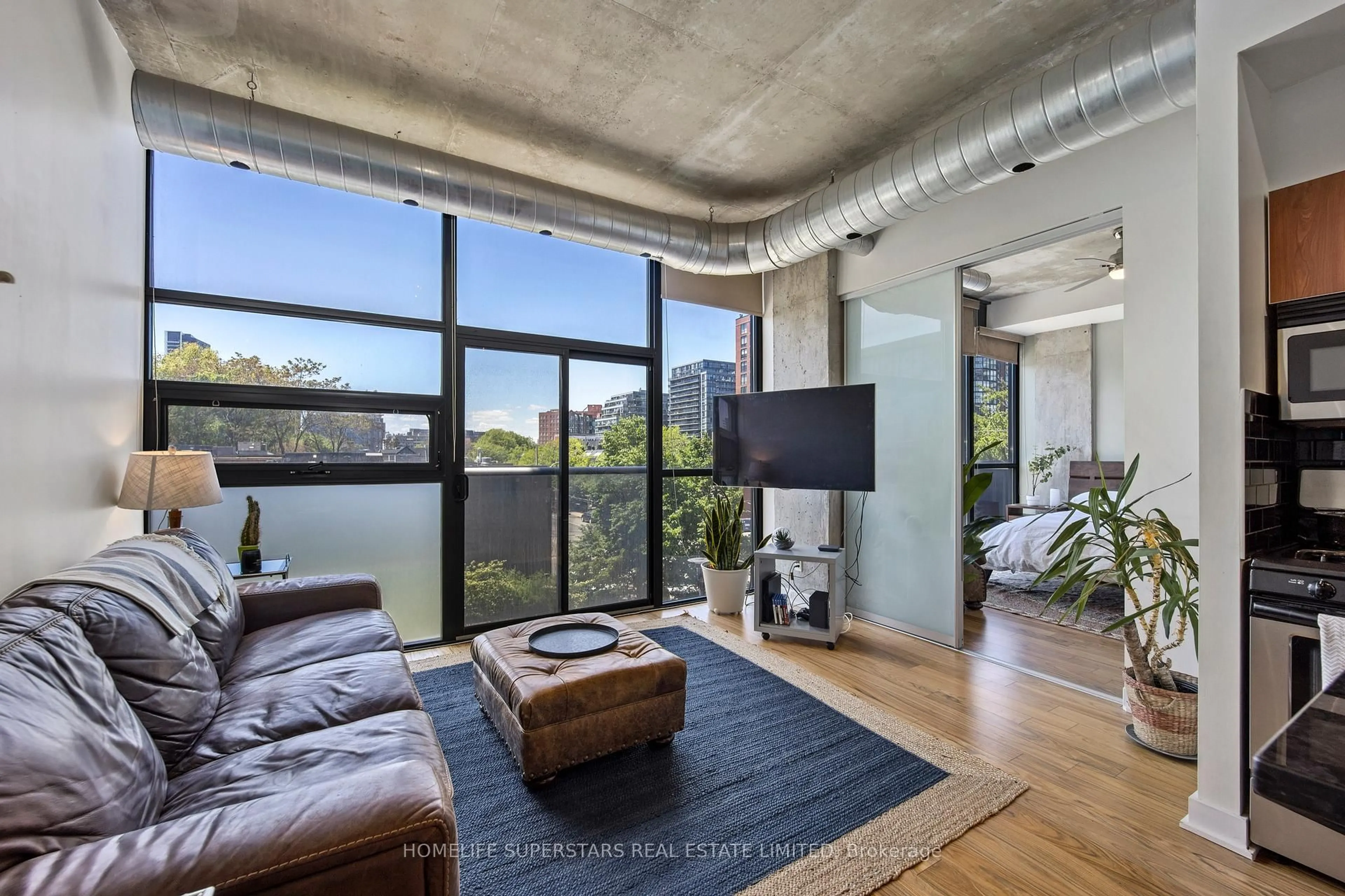 Living room with furniture, cement floor for 60 Bathurst St #303, Toronto Ontario M5V 2P4