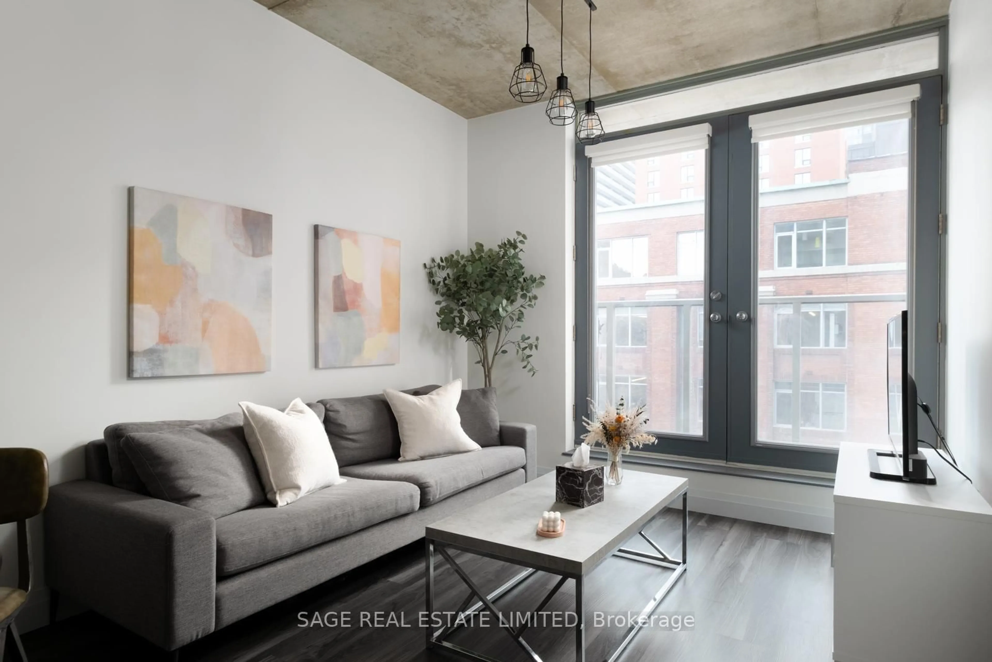 Living room with furniture, cement floor for 36 Charlotte St #603, Toronto Ontario M5V 3P7