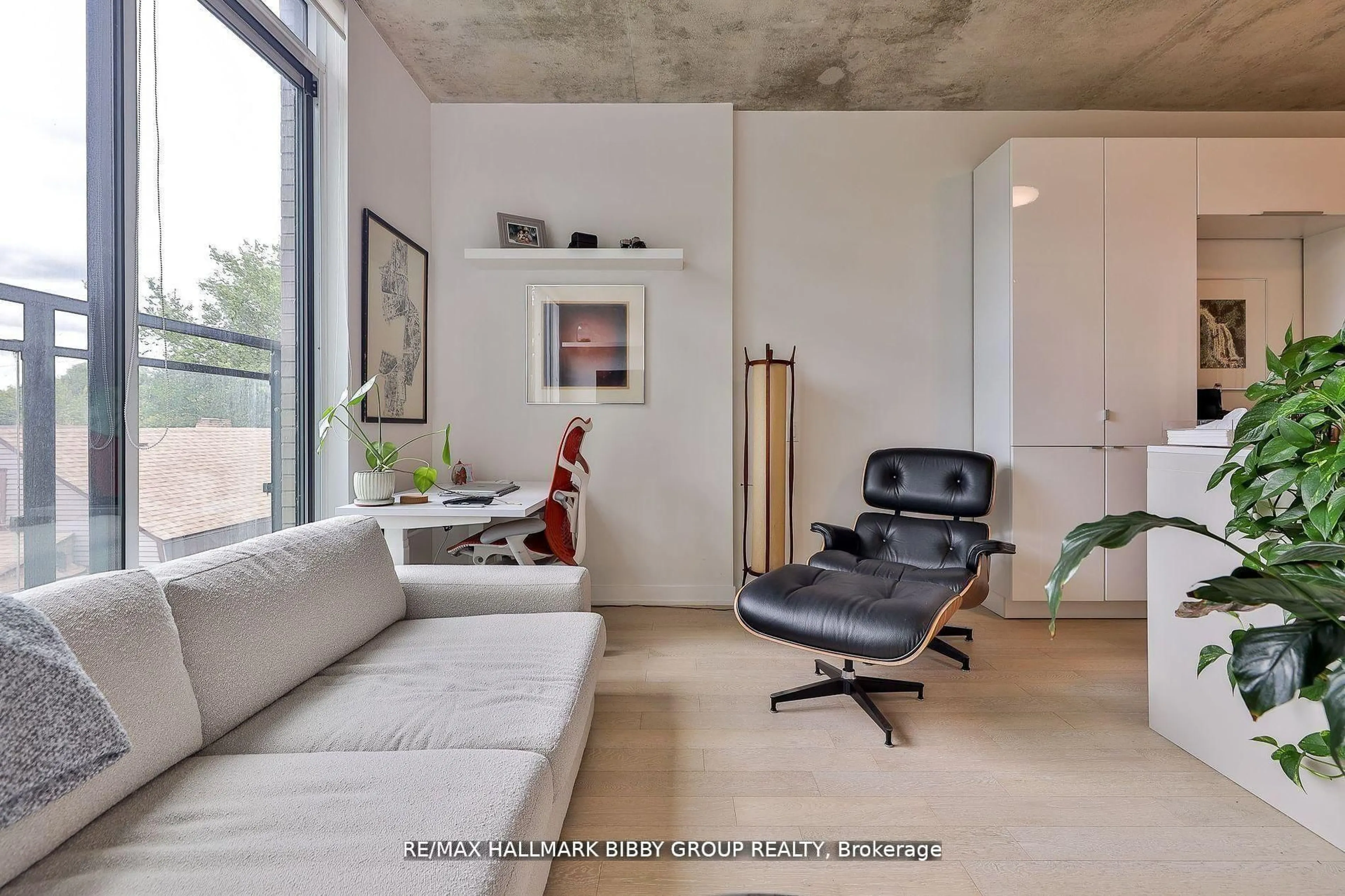 Living room with furniture, cement floor for 130 Rusholme Rd #309, Toronto Ontario M6H 1A7