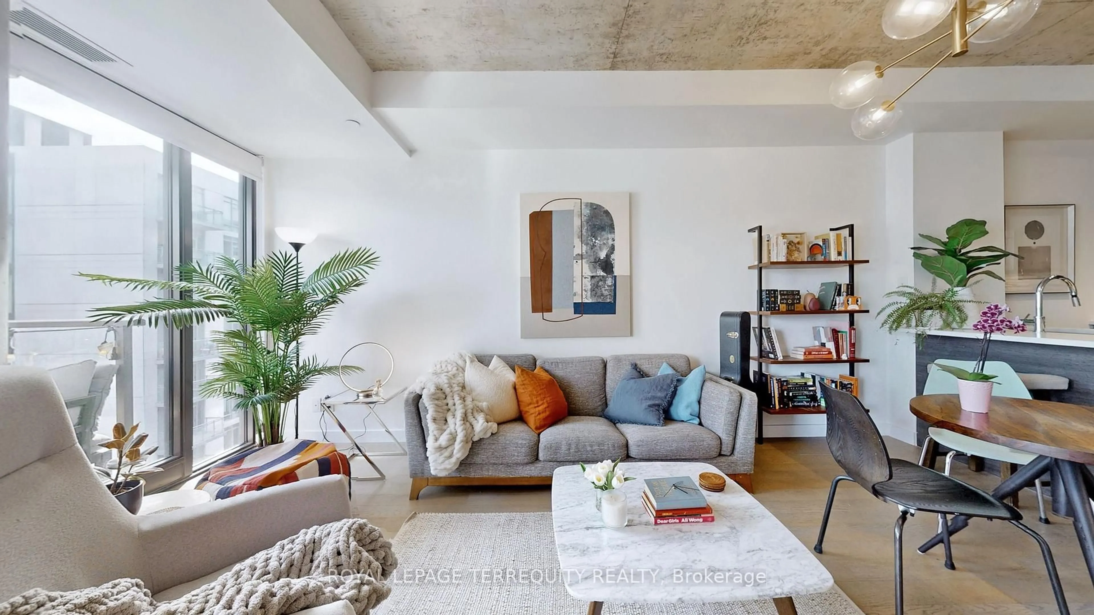 Living room with furniture, cement floor for 111 Bathurst St #1313, Toronto Ontario M5V 0M9