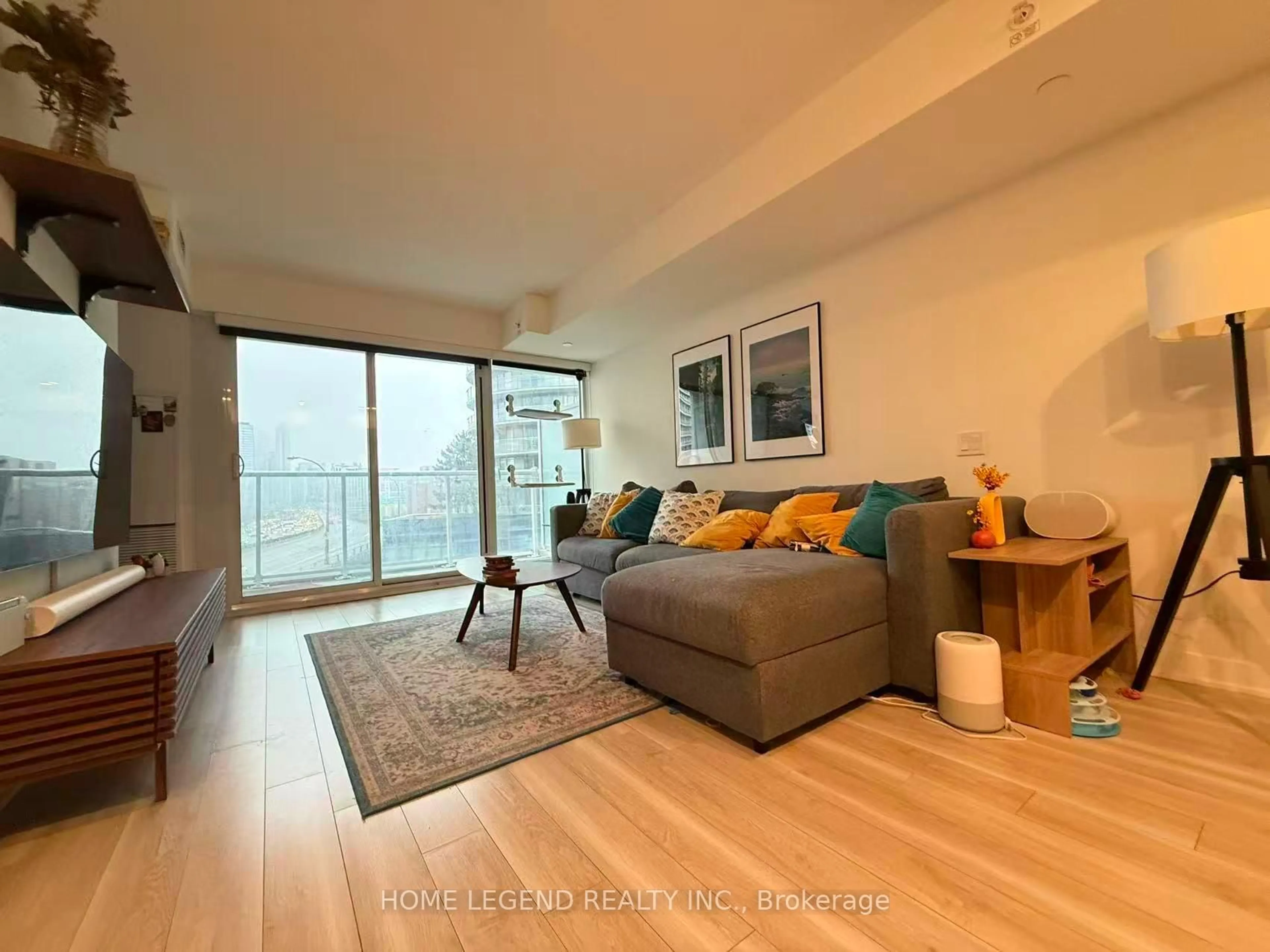 Living room with furniture, wood/laminate floor for 17 Bathurst St #710, Toronto Ontario M5V 0N1