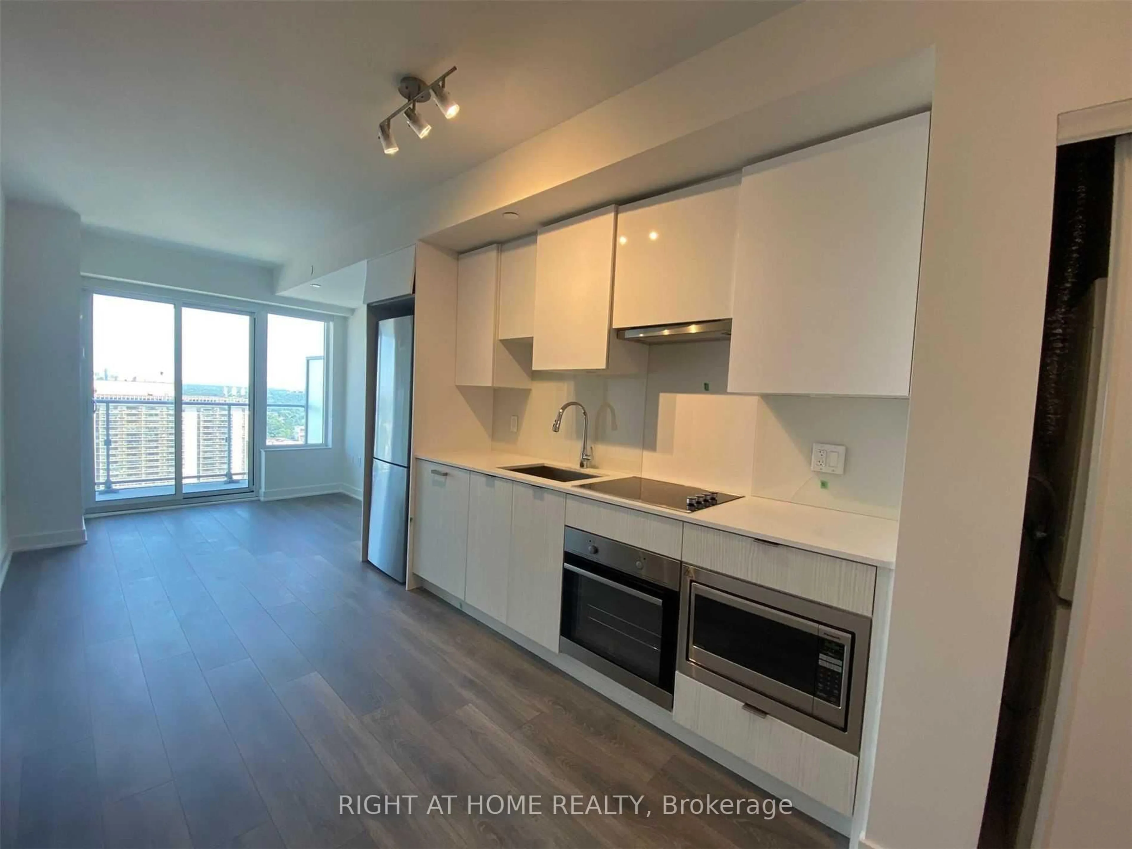 Open concept kitchen, wood/laminate floor for 99 Broadway Ave #3101, Toronto Ontario M4P 0E3