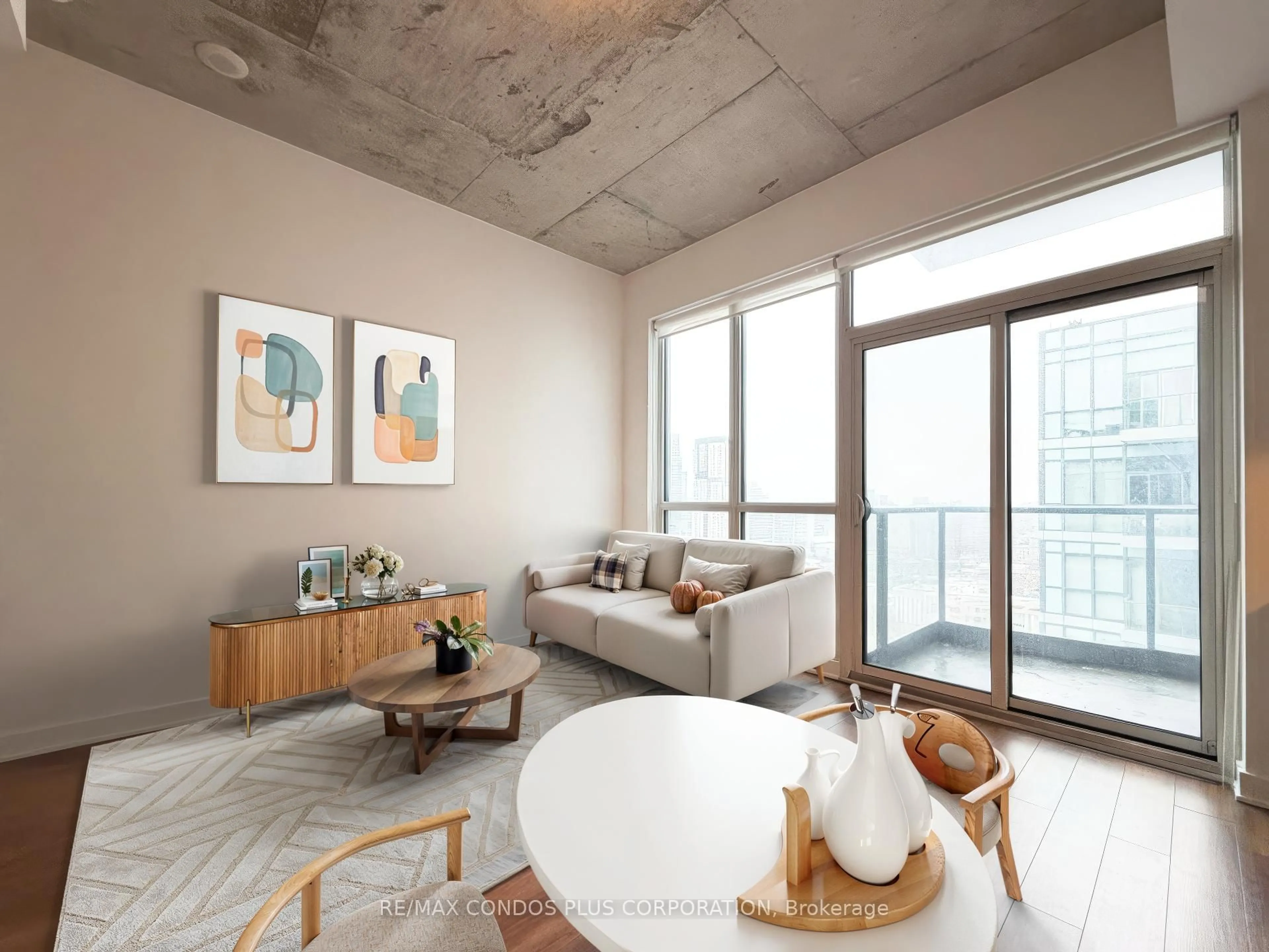 Living room with furniture, cement floor for 210 Simcoe St #2410, Toronto Ontario M5T 0A9