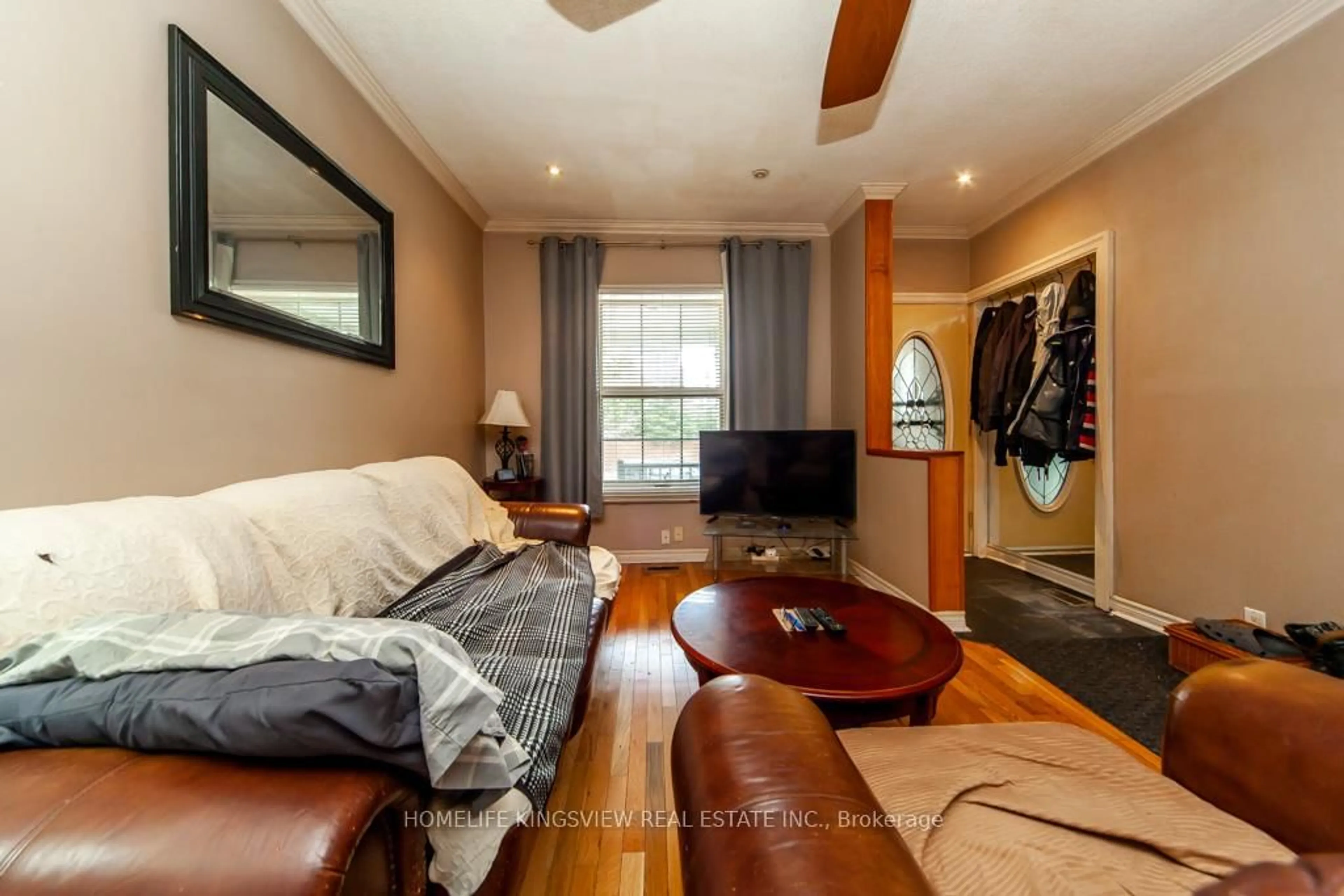 Living room with furniture, wood/laminate floor for 46 Coolmine Rd, Toronto Ontario M6J 3E9