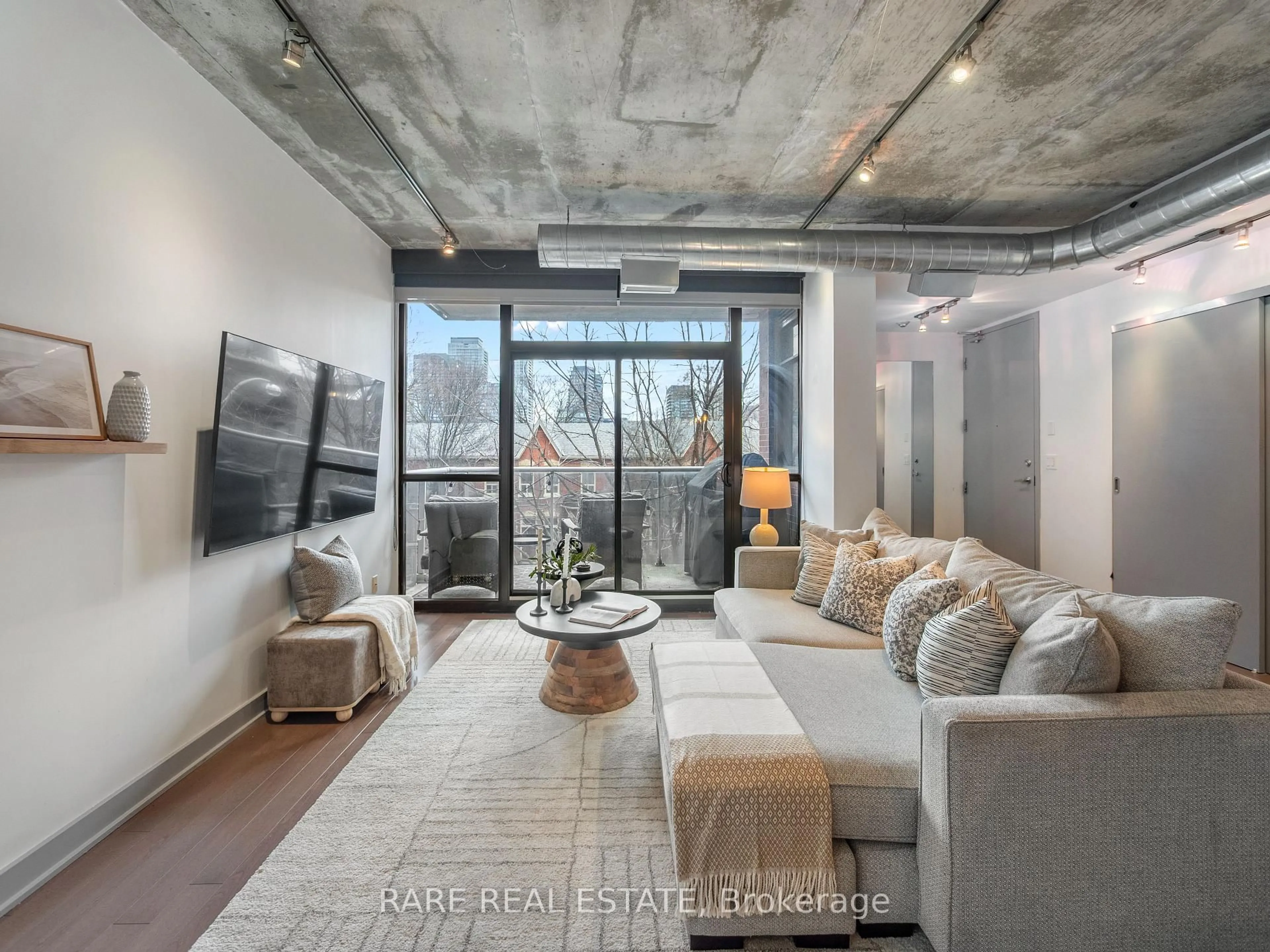 Living room with furniture, cement floor for 60 Niagara St #317, Toronto Ontario M5V 1C5