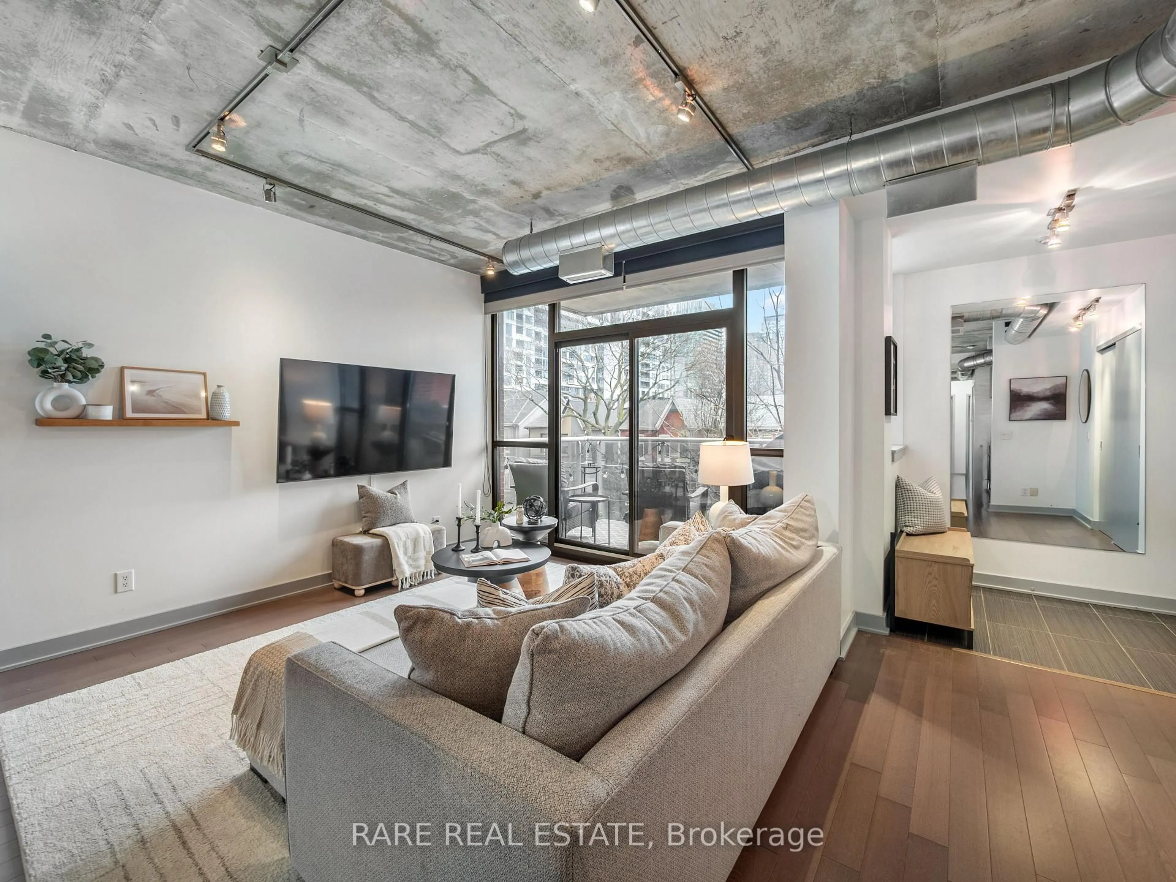 Living room with furniture, cement floor for 60 Niagara St #317, Toronto Ontario M5V 1C5