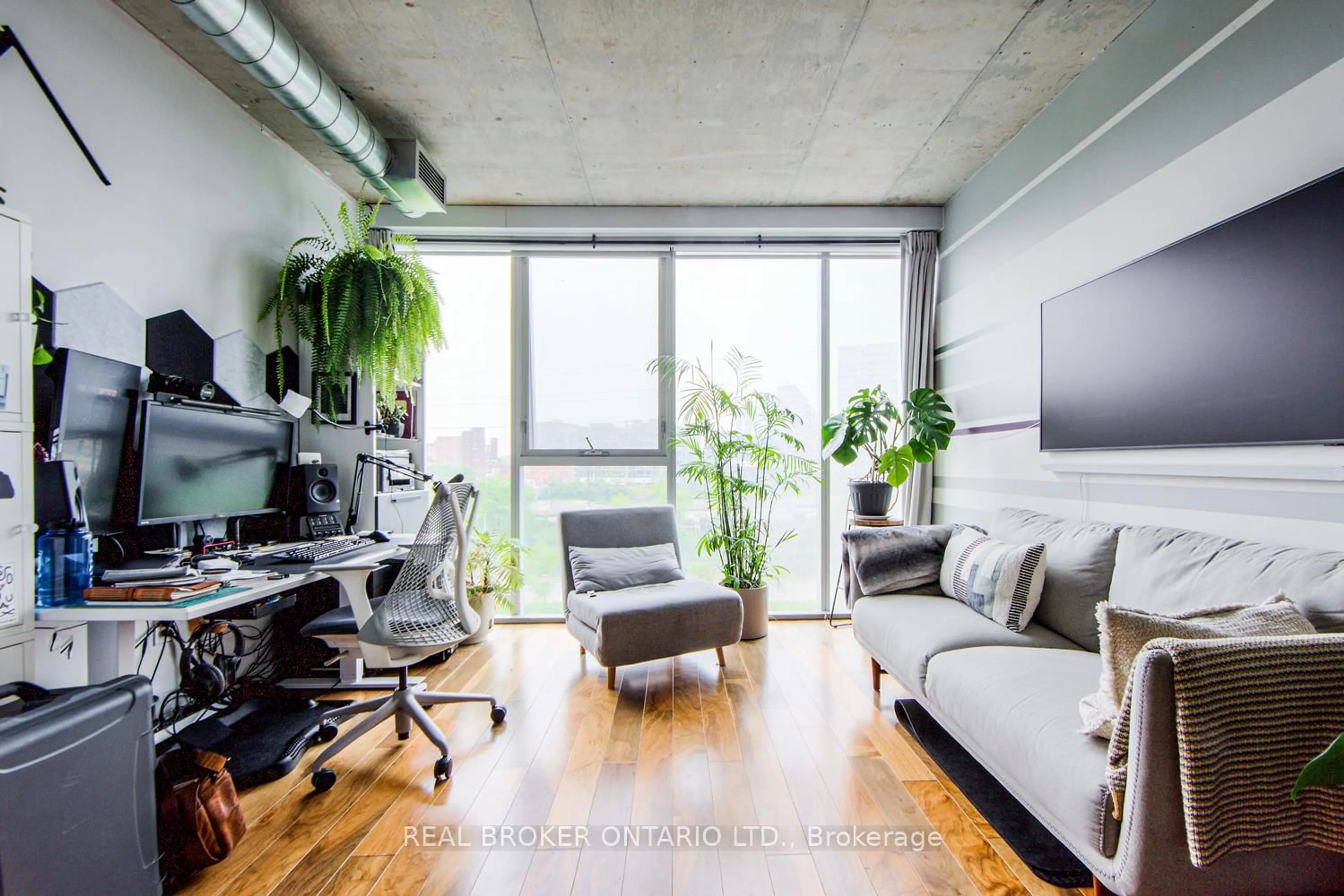 Living room with furniture, cement floor for 32 Trolley Cres #423, Toronto Ontario M5A 0E8