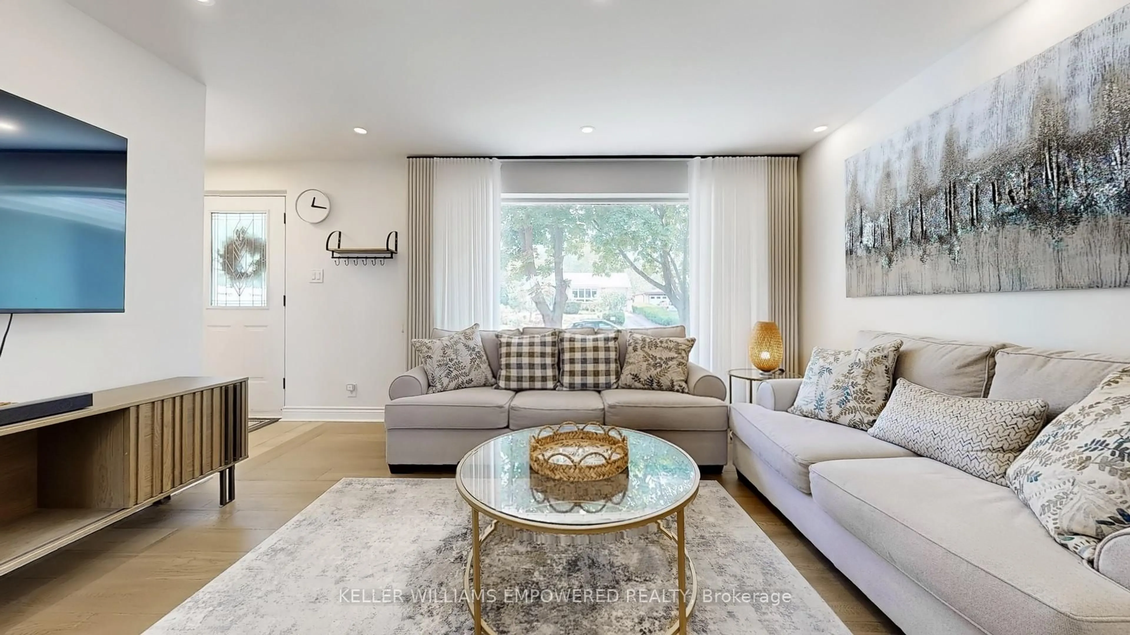 Living room with furniture, wood/laminate floor for 30 Paperbirch Dr, Toronto Ontario M3C 2E7