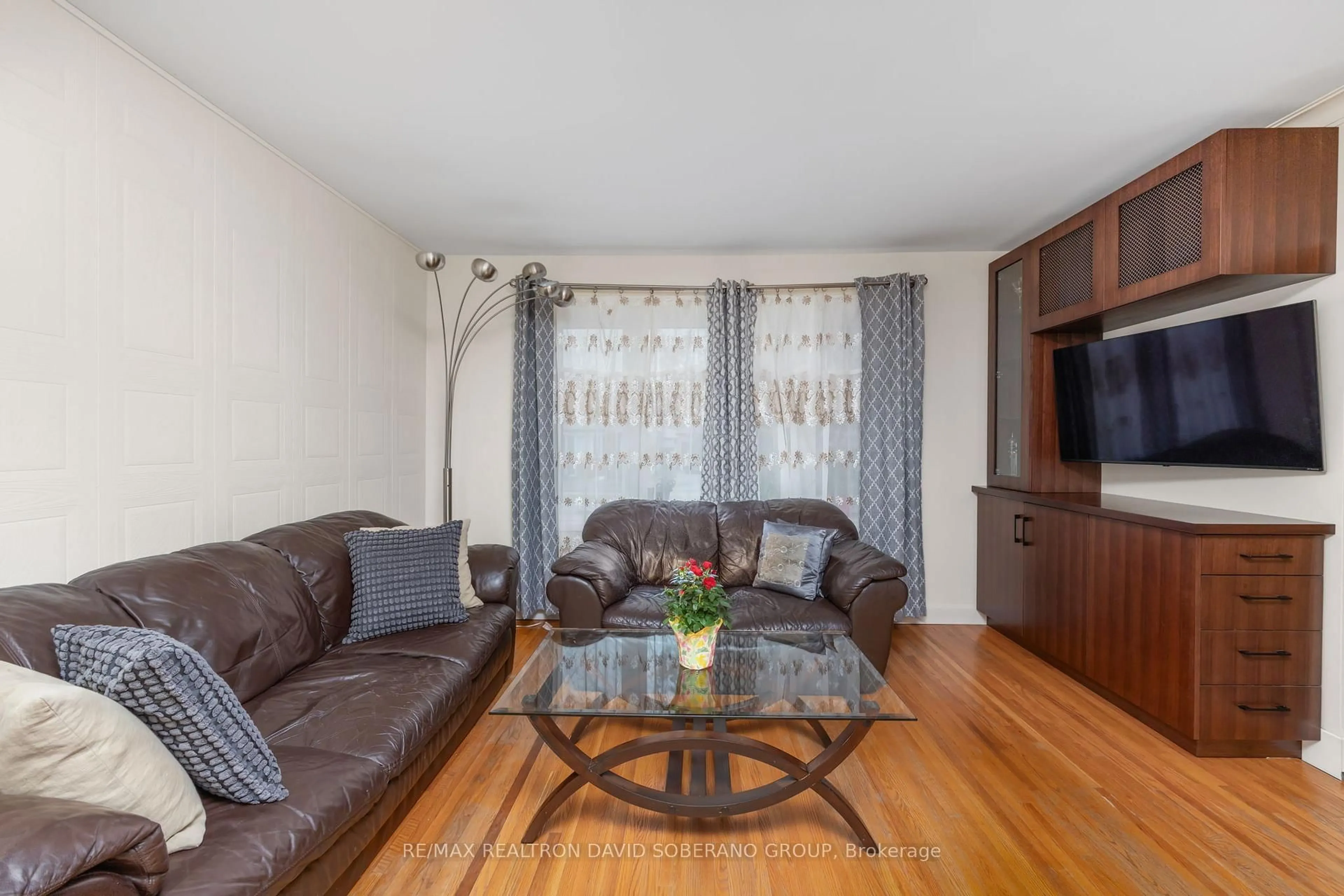 Living room with furniture, wood/laminate floor for 256 Codsell Ave, Toronto Ontario M3H 3X1