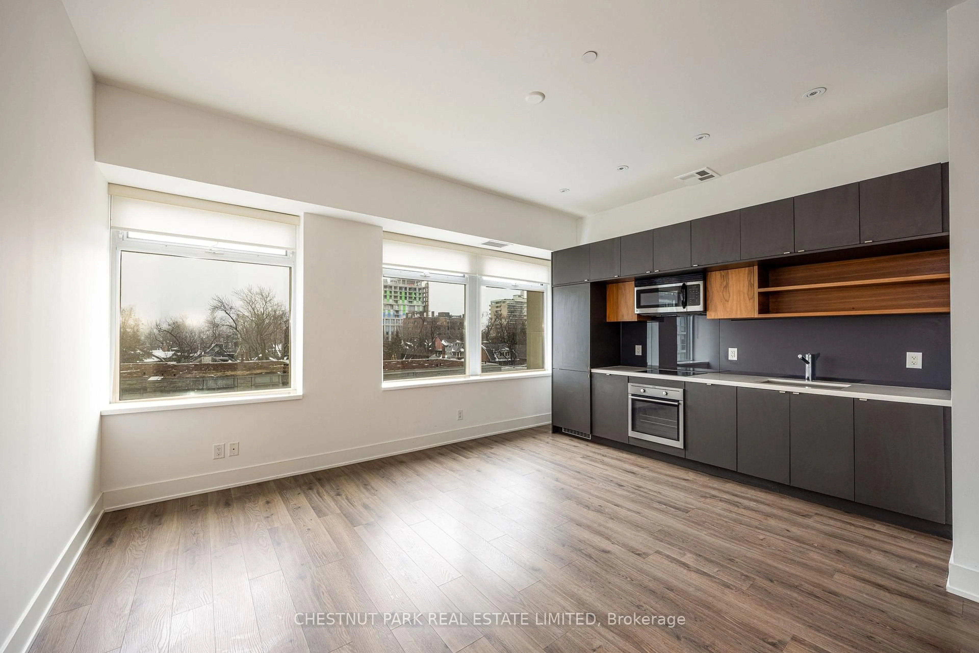 Open concept kitchen, wood/laminate floor for 111 St Clair Ave #416, Toronto Ontario M4V 1N5