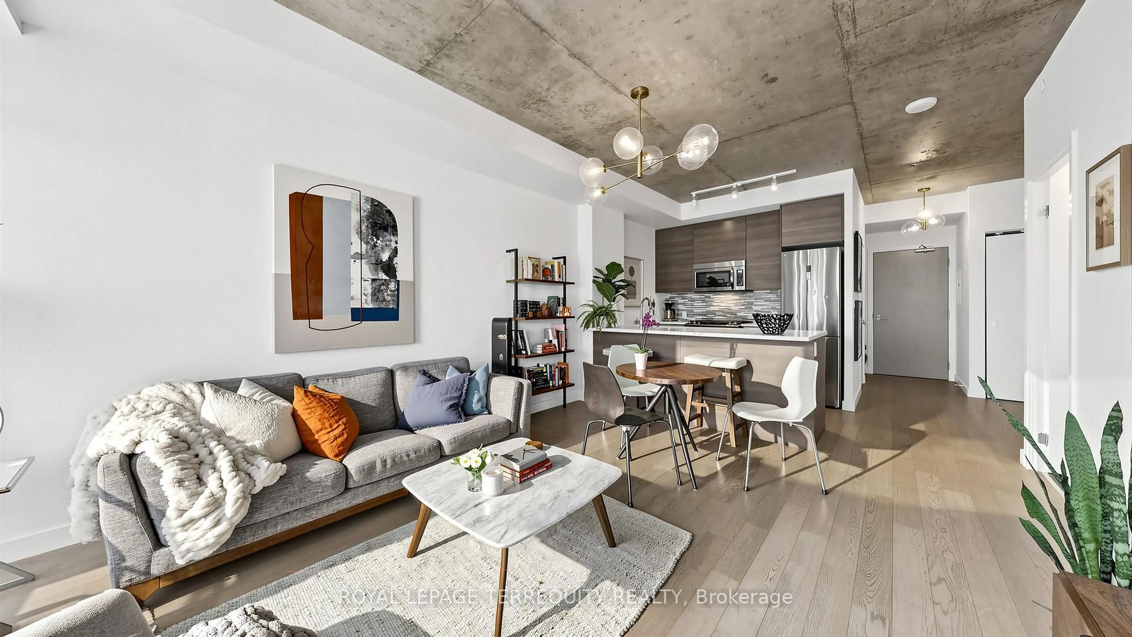 Living room with furniture, cement floor for 111 Bathurst St #1313, Toronto Ontario M5V 0M9