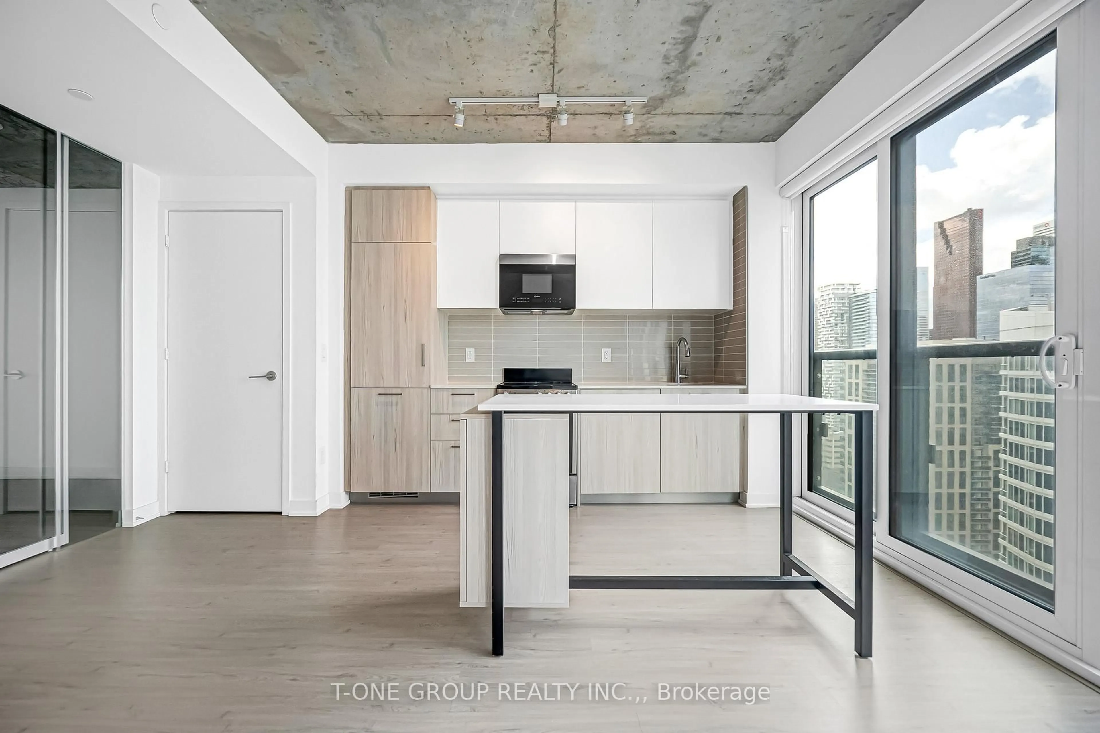 Open concept kitchen, cement floor for 65 Mutual St #2605, Toronto Ontario M5B 2A9