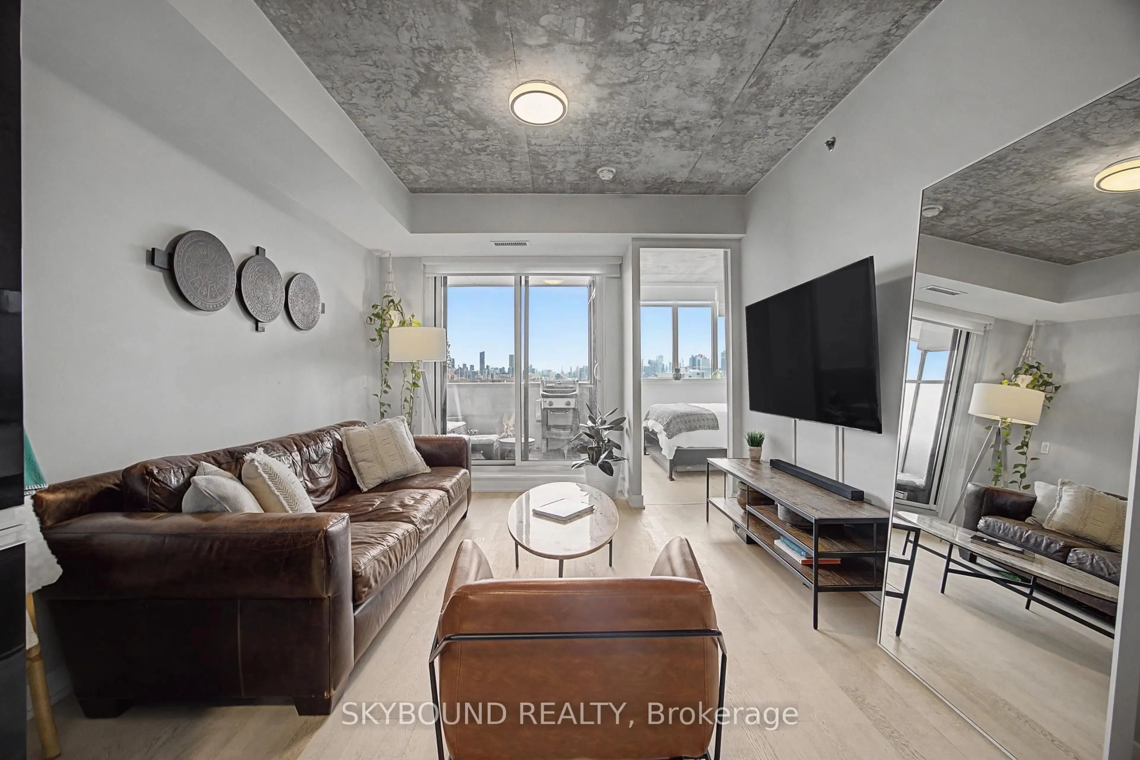 Living room with furniture, cement floor for 20 Minowan Miikan Lane #1023, Toronto Ontario M6J 0E5