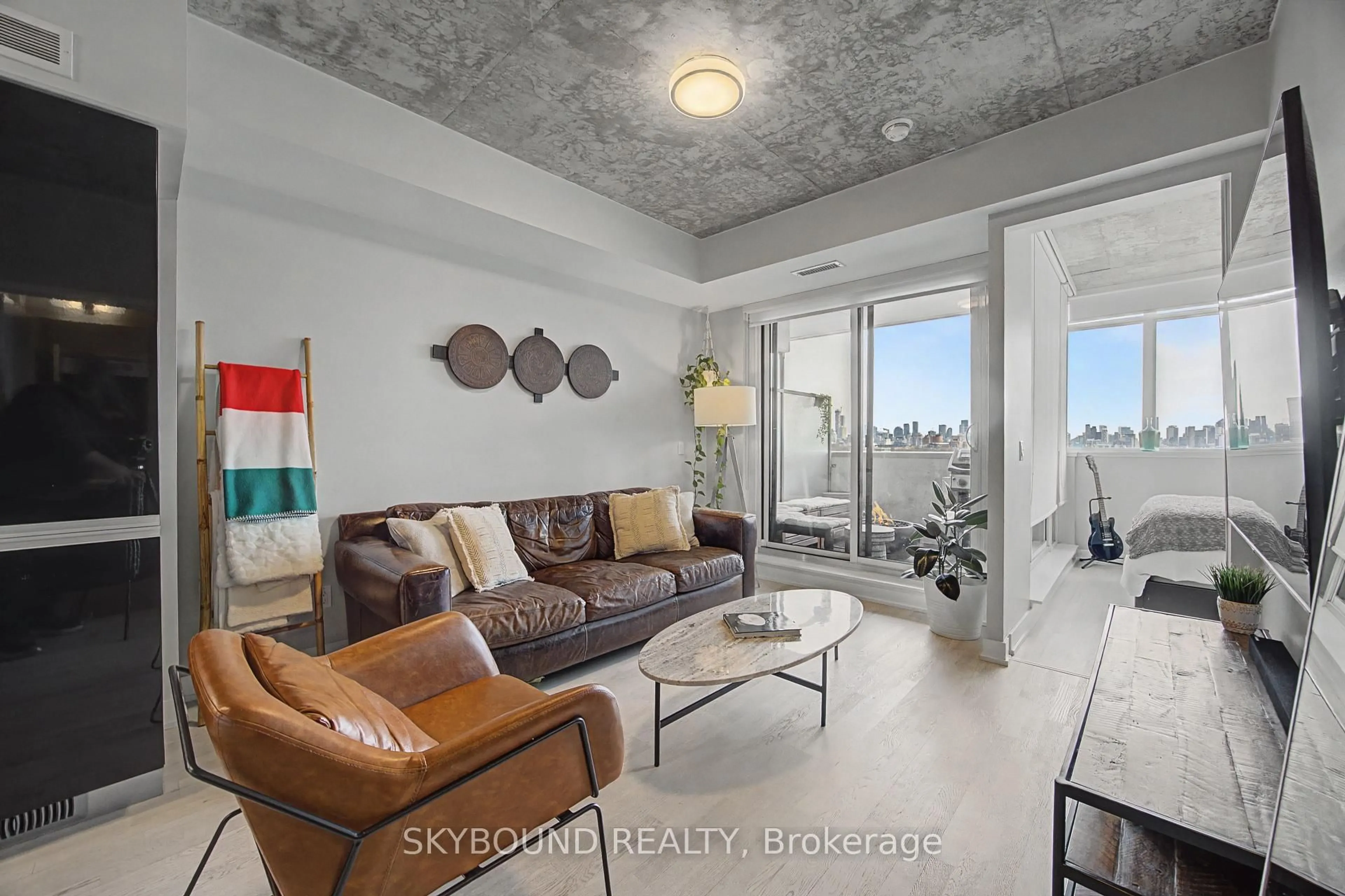 Living room with furniture, cement floor for 20 Minowan Miikan Lane #1023, Toronto Ontario M6J 0E5