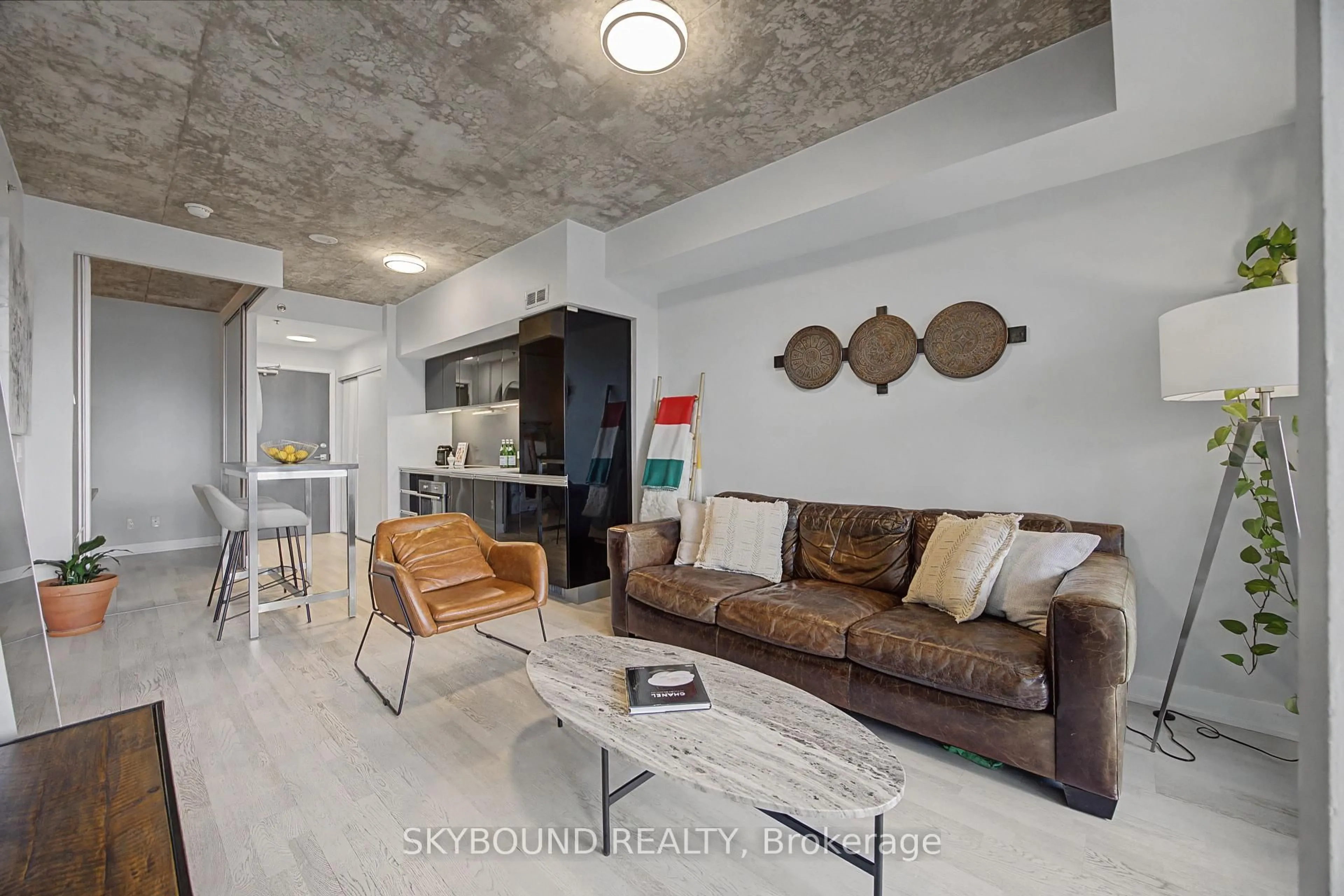 Living room with furniture, cement floor for 20 Minowan Miikan Lane #1023, Toronto Ontario M6J 0E5