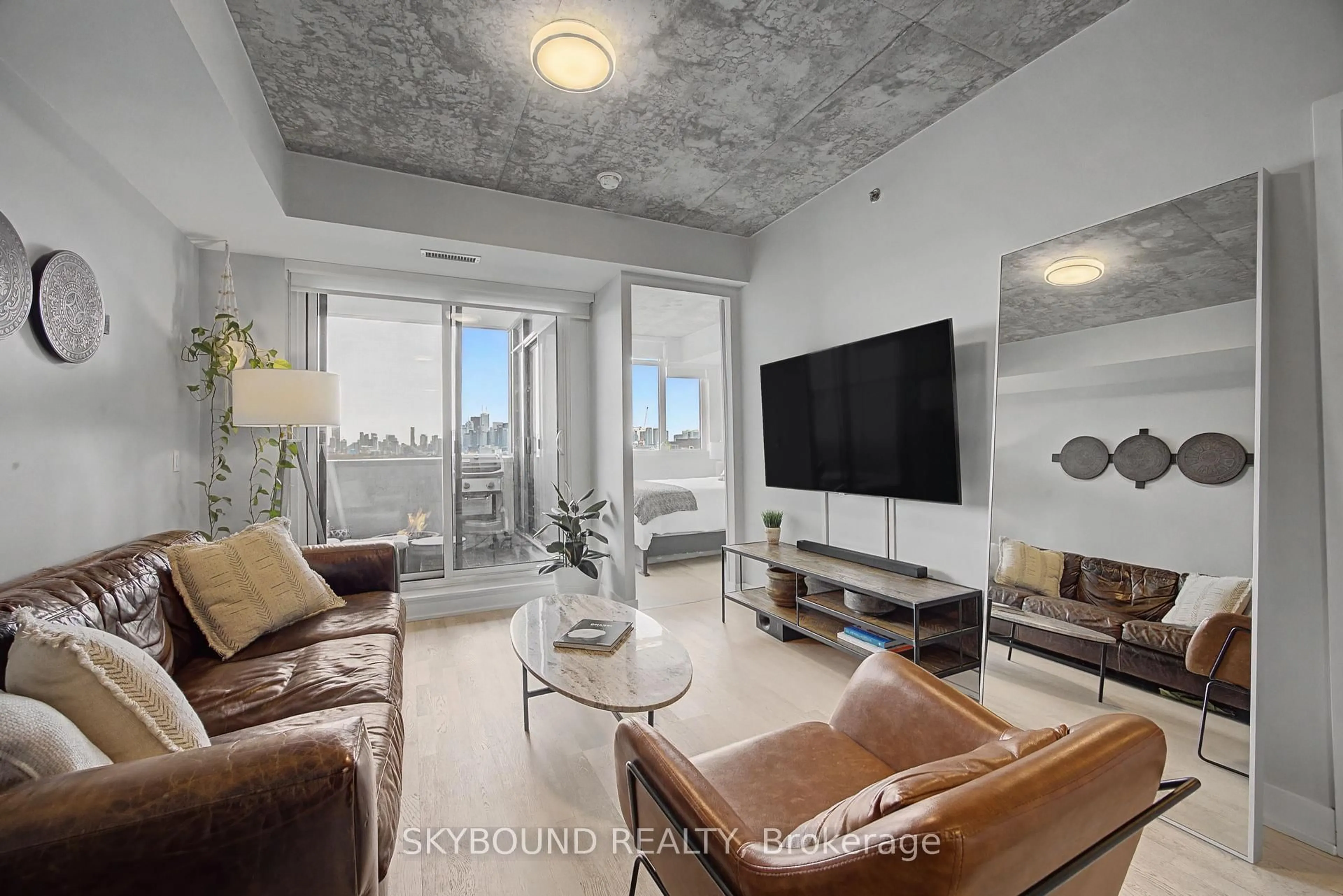 Living room with furniture, cement floor for 20 Minowan Miikan Lane #1023, Toronto Ontario M6J 0E5