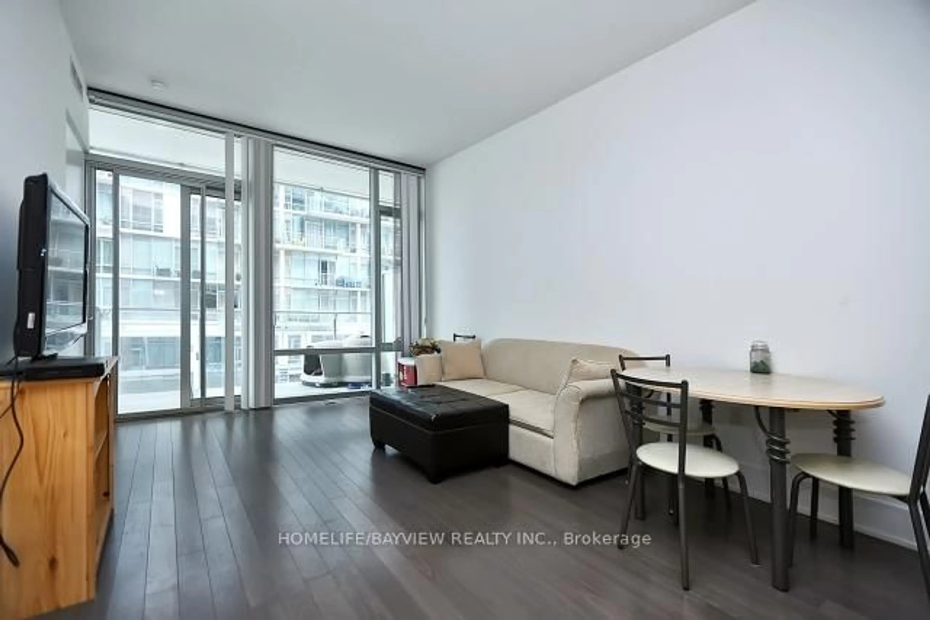 Living room with furniture, wood/laminate floor for 39 Queens Quay #308, Toronto Ontario M5E 0A5
