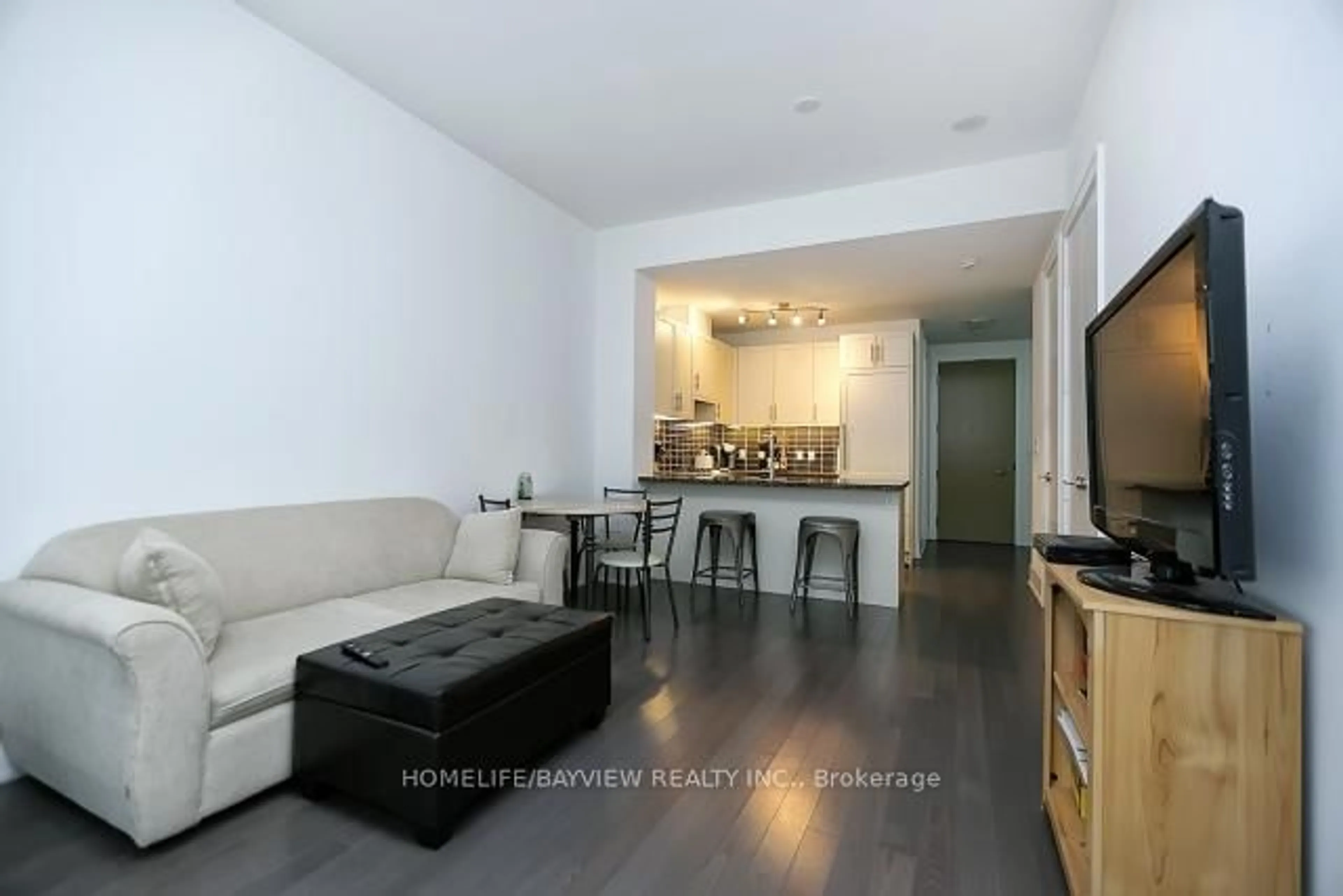 Living room with furniture, wood/laminate floor for 39 Queens Quay #308, Toronto Ontario M5E 0A5