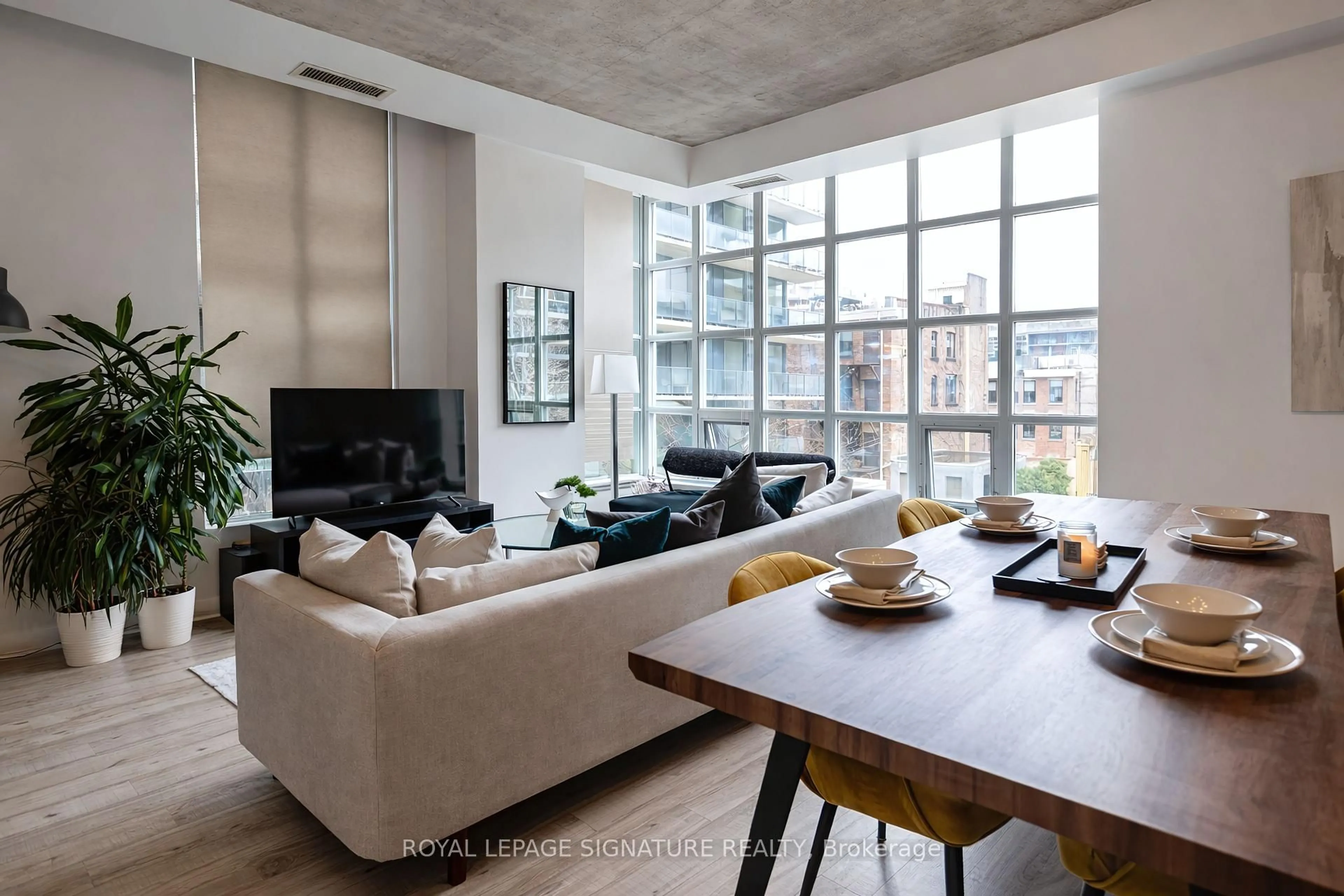 Living room with furniture, cement floor for 23 Brant St #305, Toronto Ontario M5V 2L5