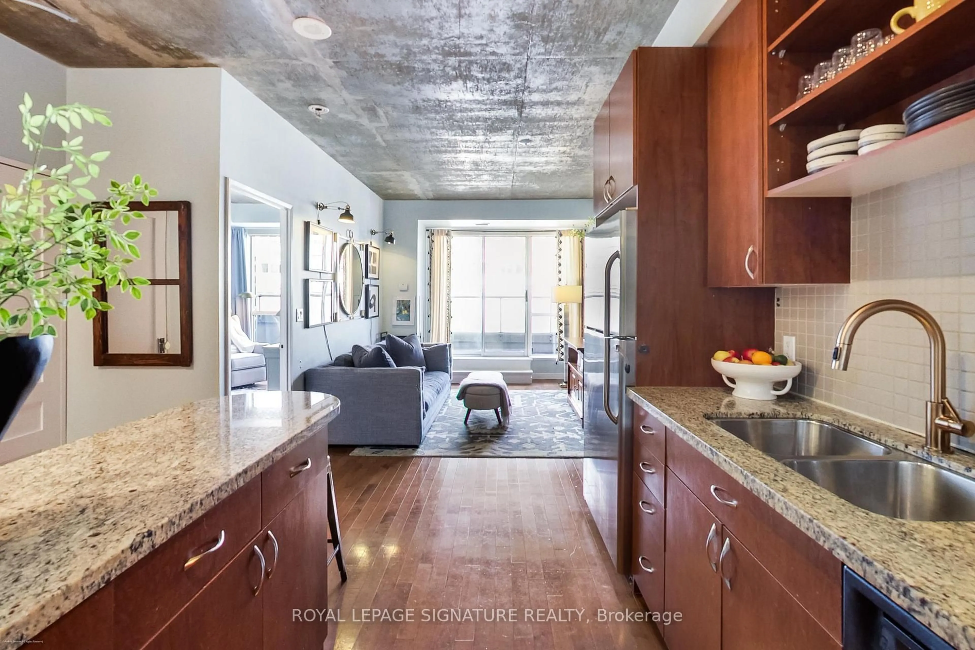 Open concept kitchen, cement floor for 1005 King St #718, Toronto Ontario M6K 3M8