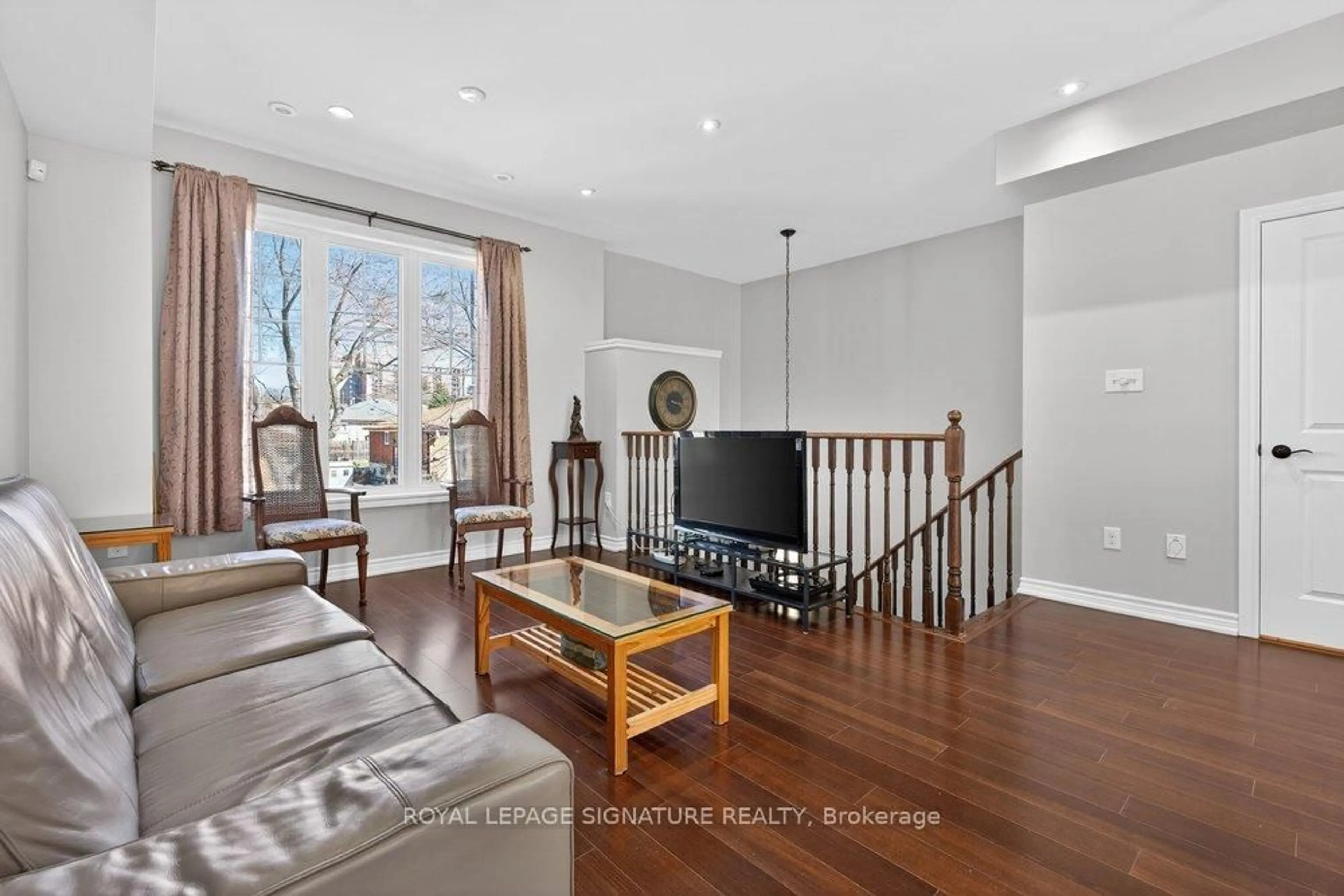 Living room with furniture, wood/laminate floor for 28 Tisdale Ave, Toronto Ontario M4A 1Y5