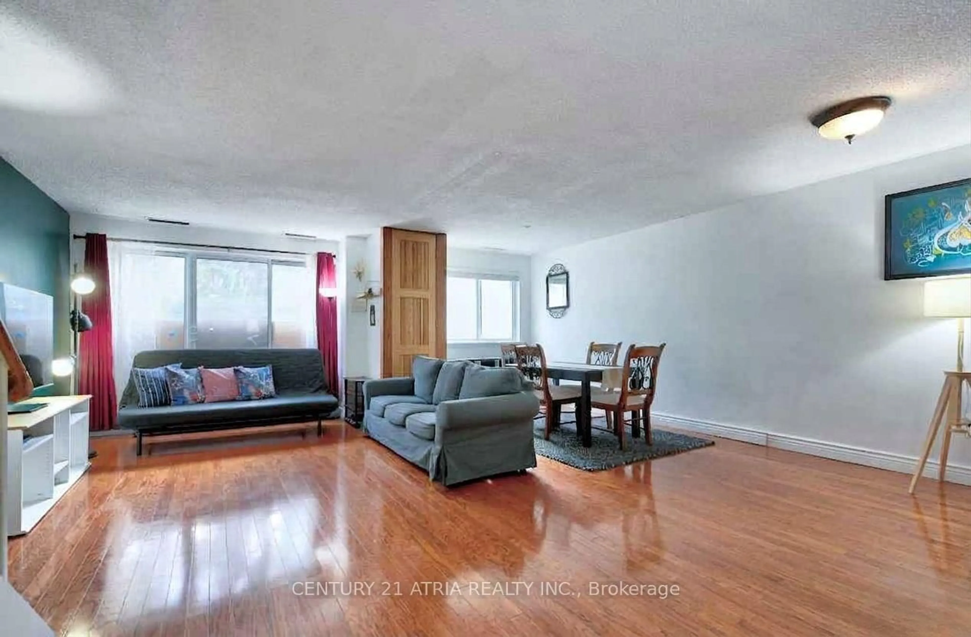 Living room with furniture, wood/laminate floor for 4001 Don Mills Rd #135, Toronto Ontario M2H 3J8