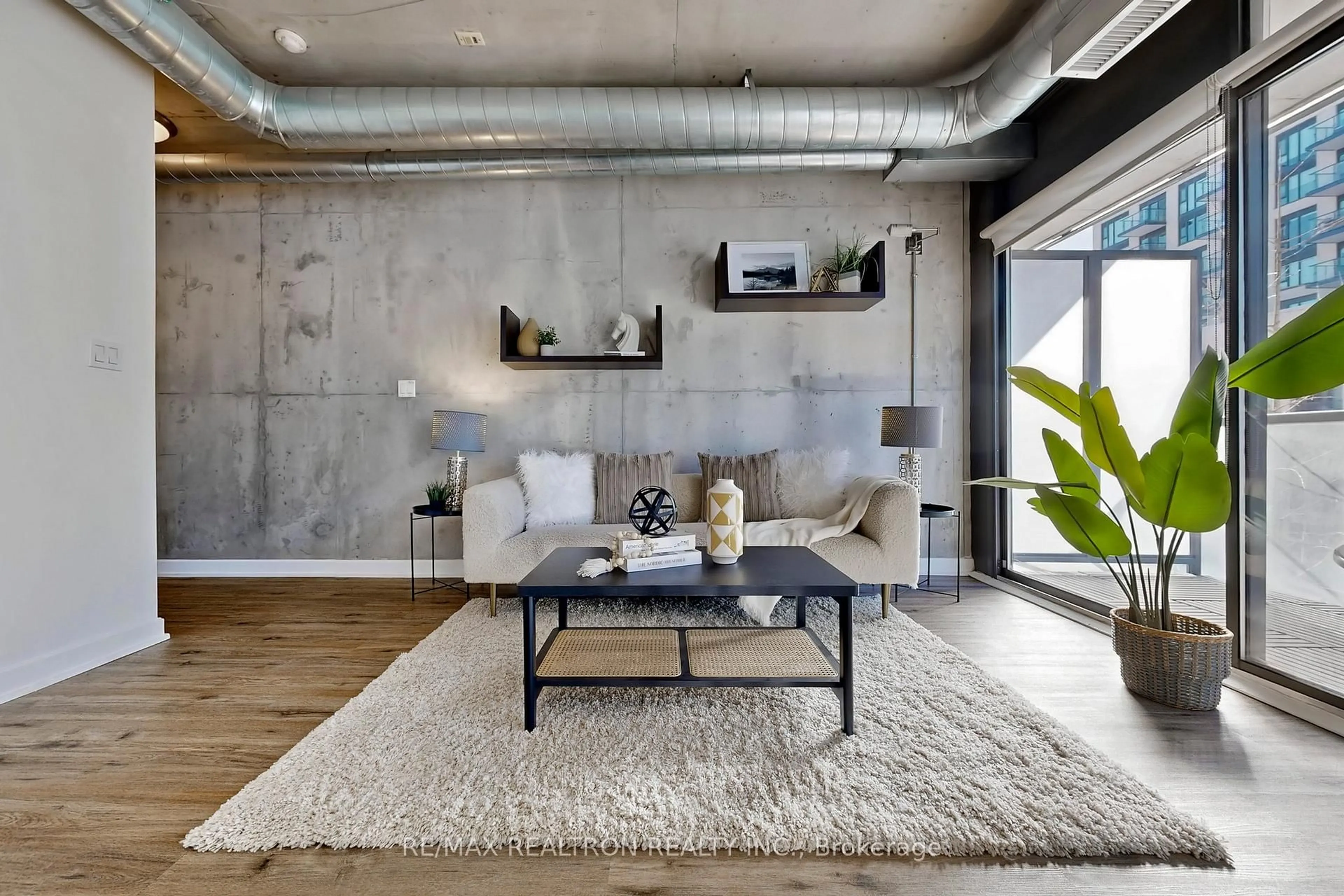 Living room with furniture, cement floor for 533 Richmond St #408, Toronto Ontario M5V 3Y1