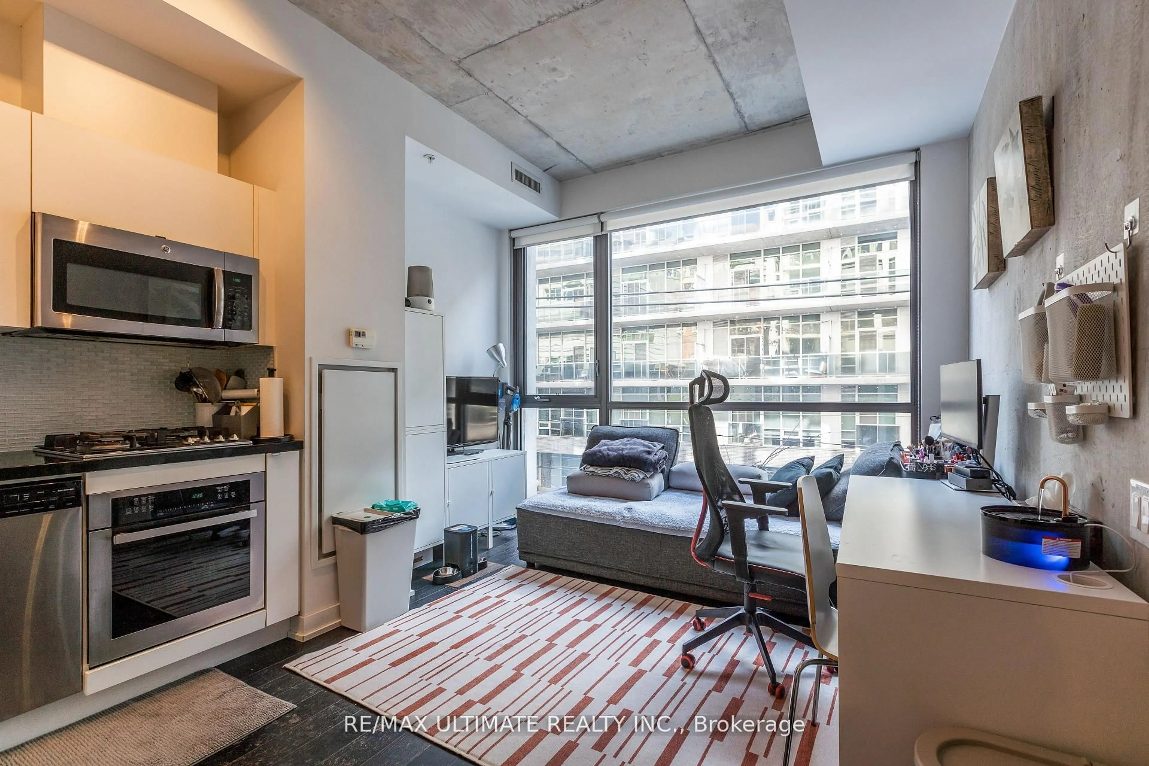 Open concept kitchen, cement floor for 39 Brant St #206, Toronto Ontario M5V 0M8
