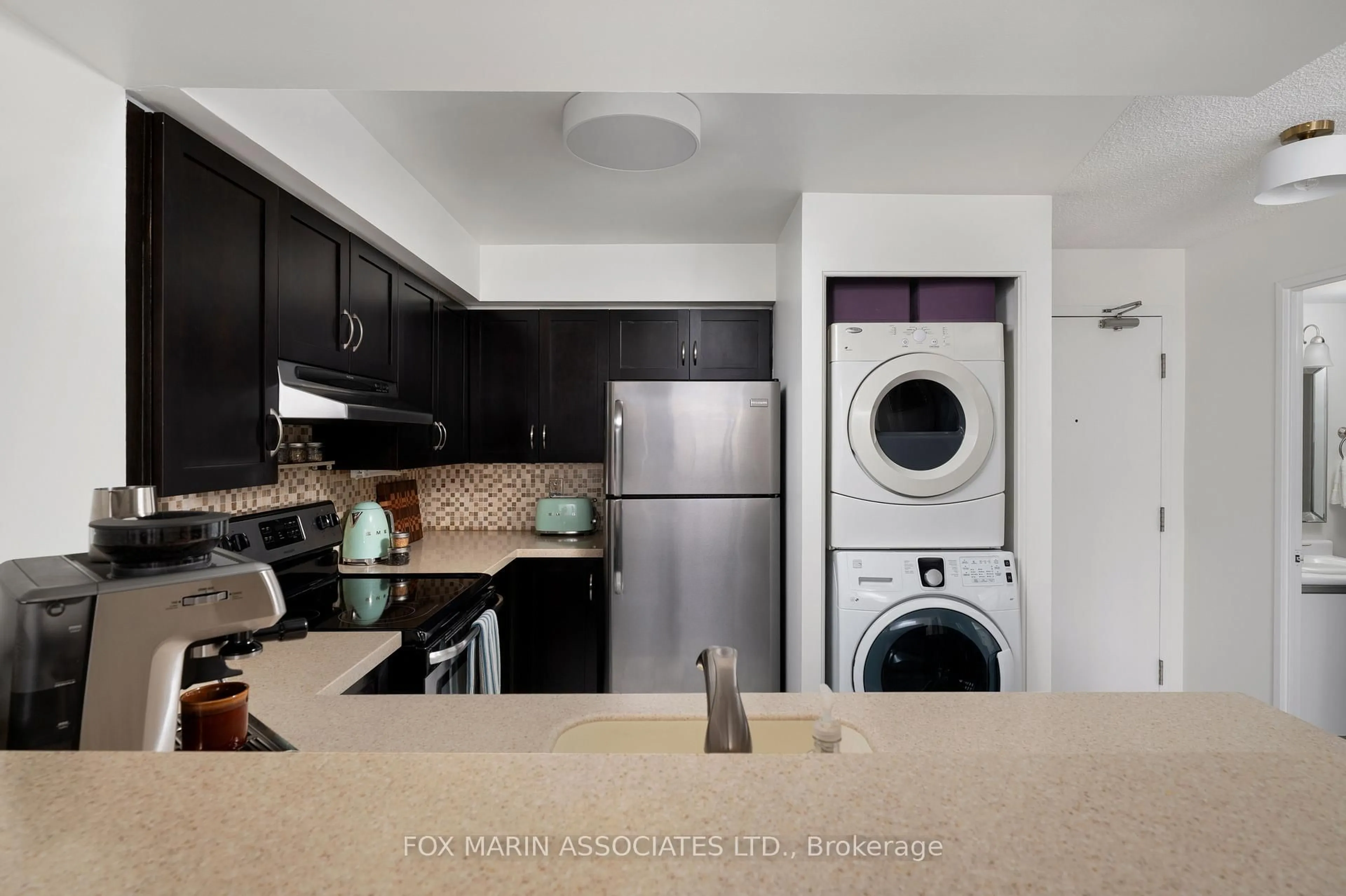 Kitchen with laundary machines, ceramic/tile floor for 801 King St #815, Toronto Ontario M5V 3C9