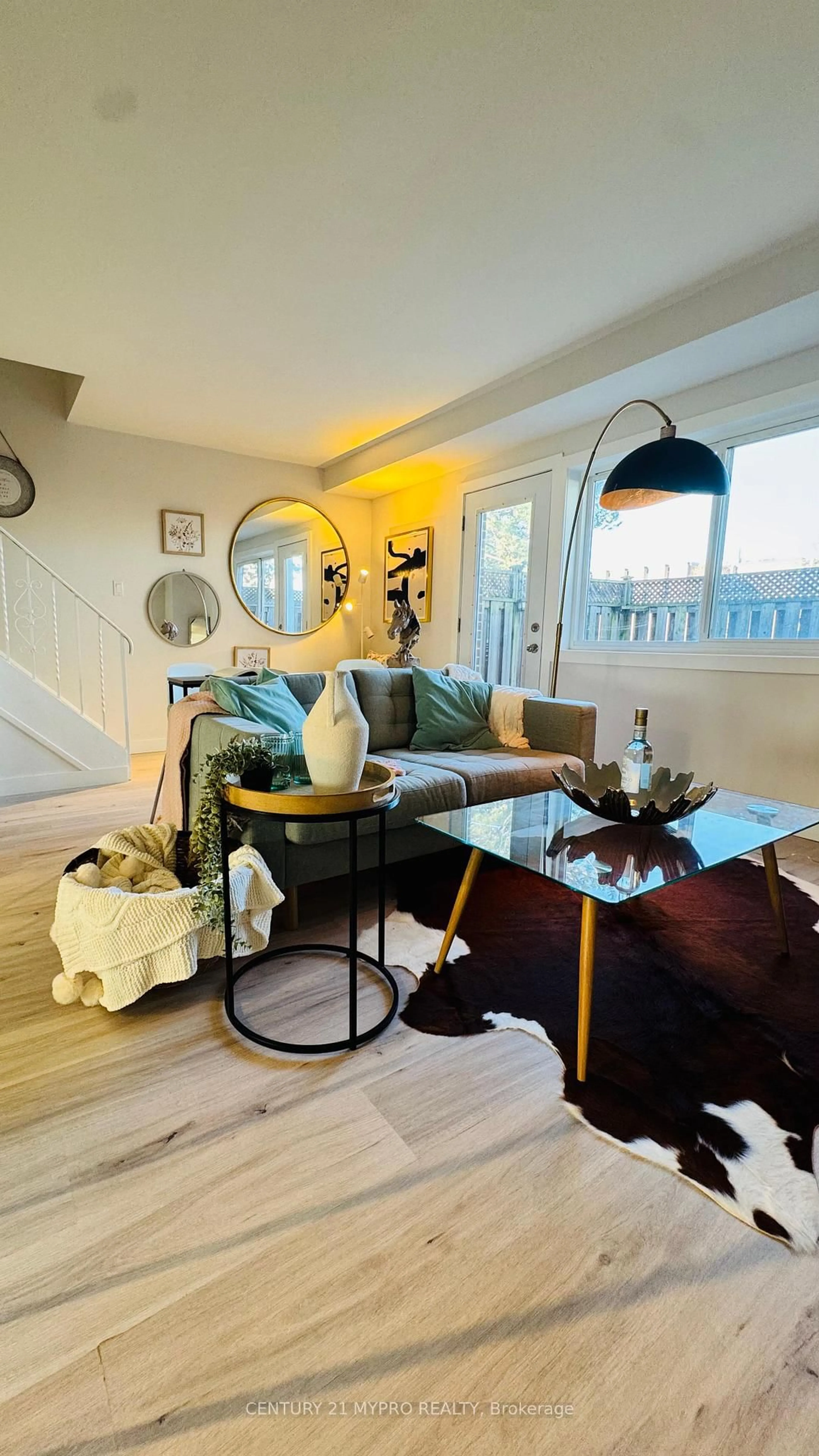 Living room with furniture, wood/laminate floor for 67 godstone Rd #121, Toronto Ontario M2J 3C8